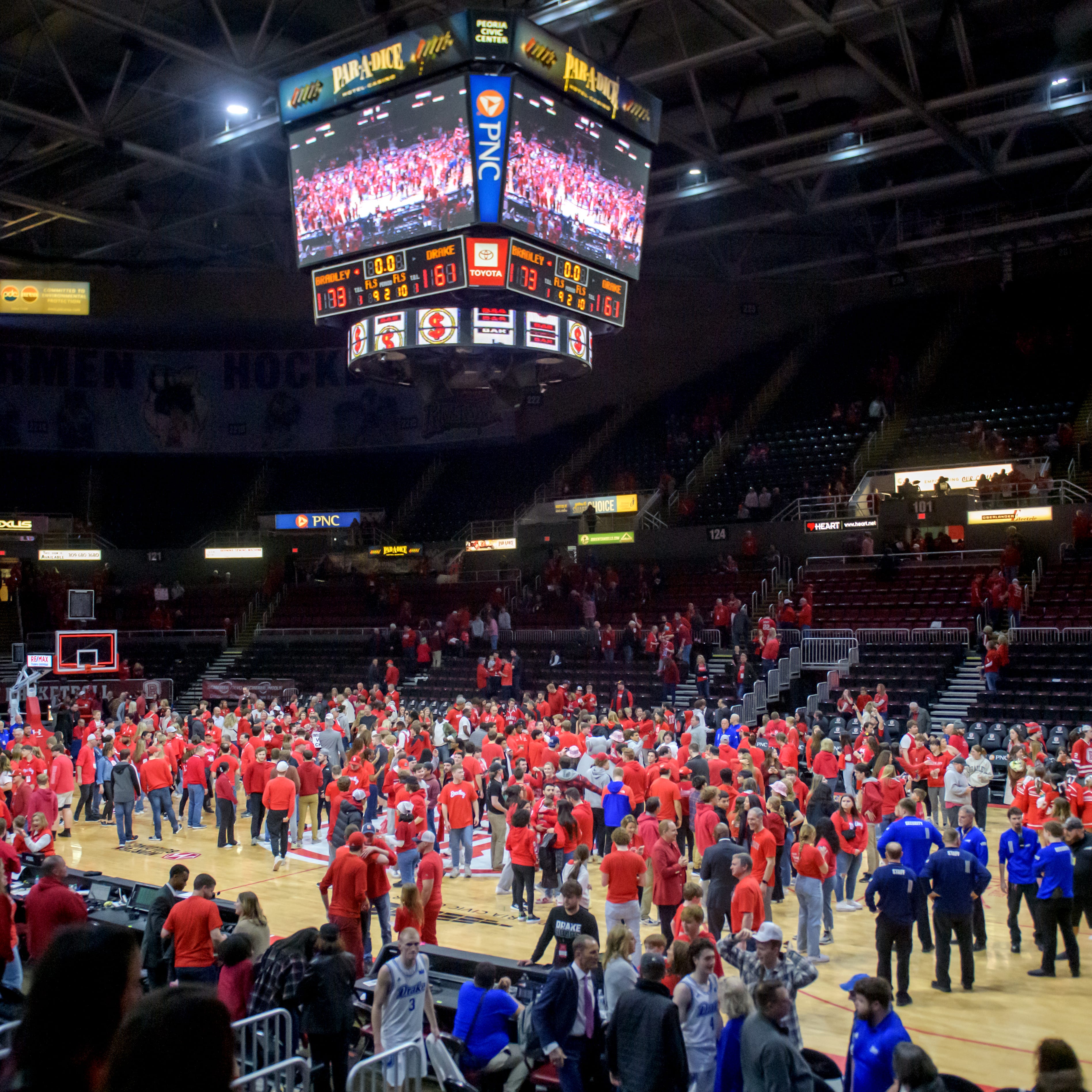 A large crowd remains on the floor after the Bradley Braves' 73-61 defeat of Drake for the MVC championship Sunday, Feb. 26, 2023 at Carver Arena.