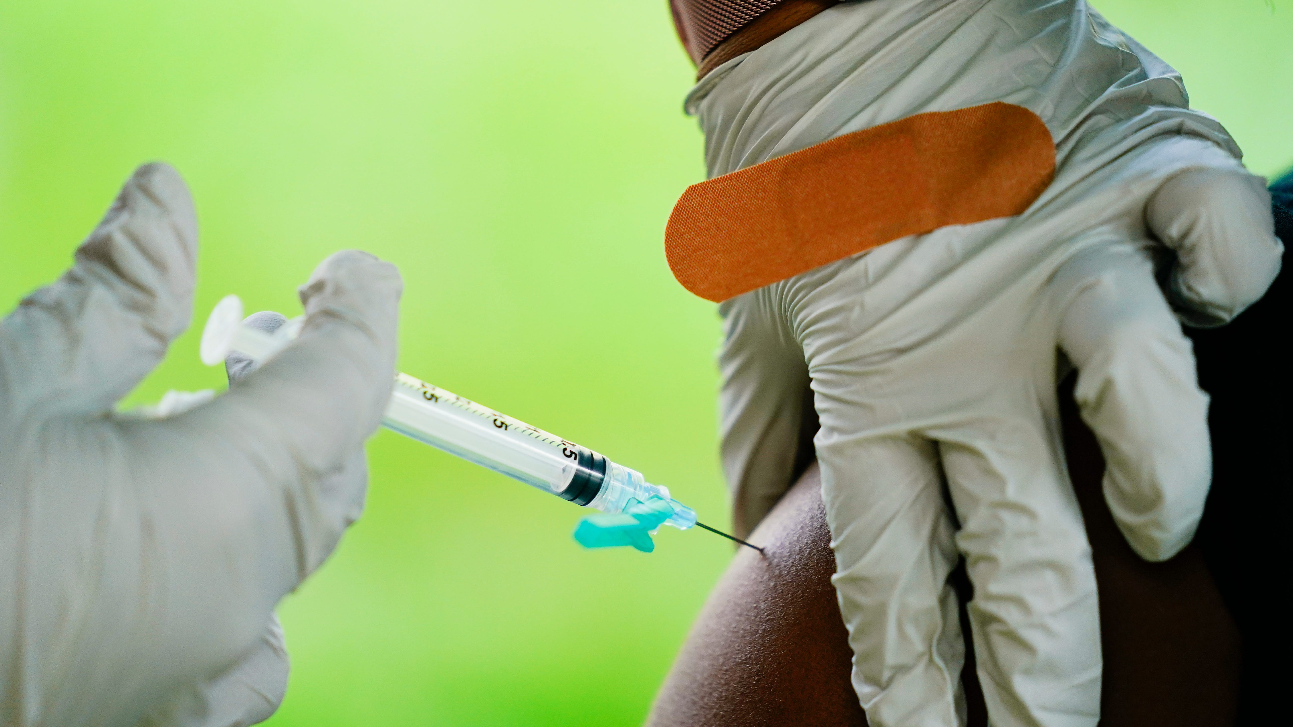 A health worker administers a dose of COVID-19 vaccine during a vaccination clinic in Reading, Pa. On Friday, Feb. 3, 2023.