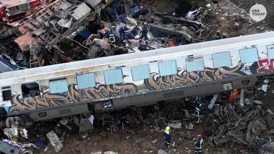 Firefighters and rescuers operate after a collision in Tempe near Larissa city, Greece, Wednesday, March 1, 2023. A train carrying hundreds of passengers has collided with an oncoming freight train in northern Greece, killing and injuring dozens passengers.