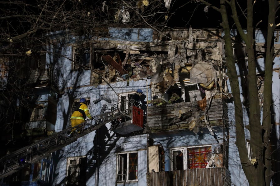 Ukrainian State Emergency Service firefighters inspect a damaged house after Russian shelling hit Zaporizhzhia, Ukraine, Thursday, March 2, 2023.