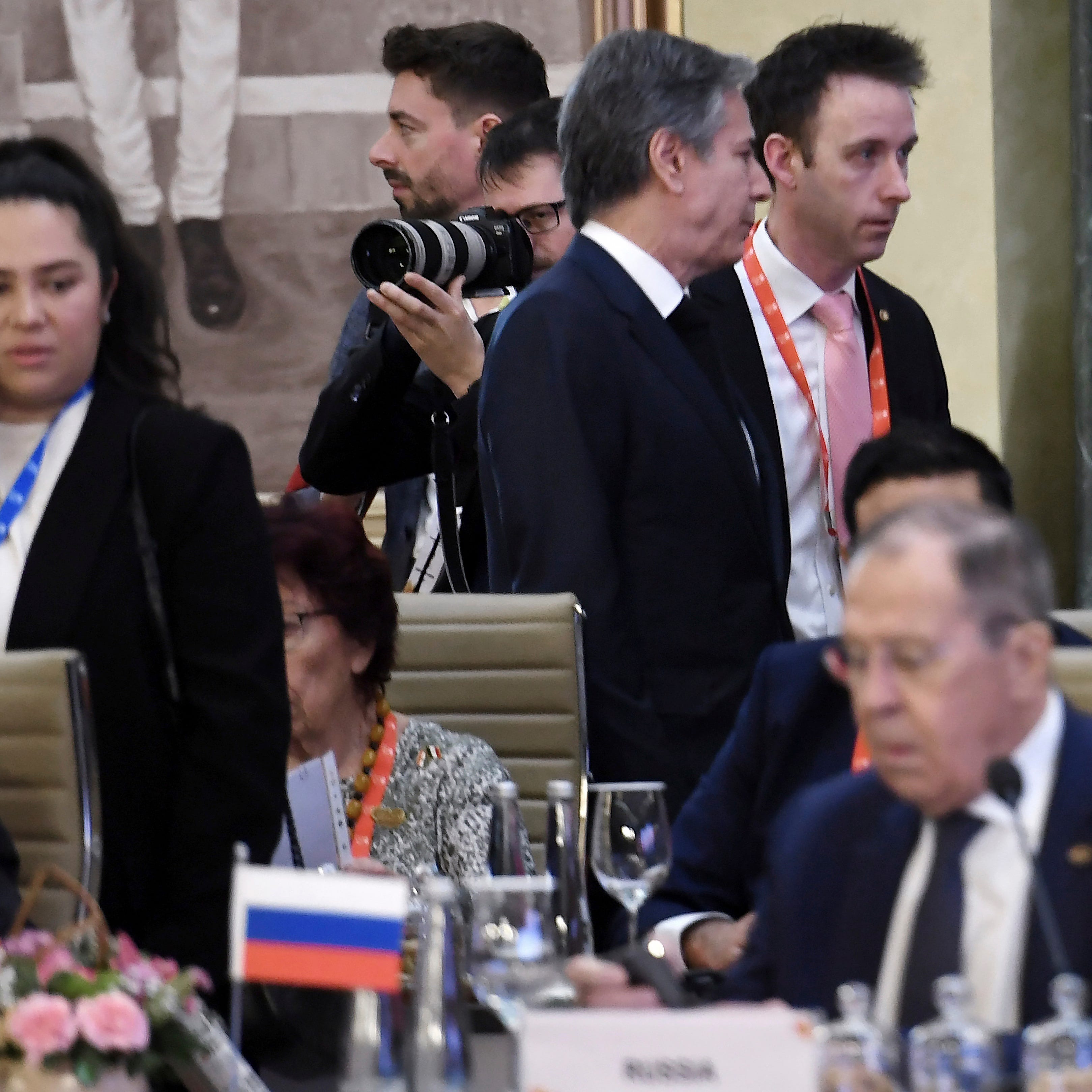 U.S. Secretary of State Antony Blinken, top center, walks past Russian Foreign Minister Sergey Lavrov during the G-20 foreign ministers' meeting in New Delhi, on March 2, 2023.