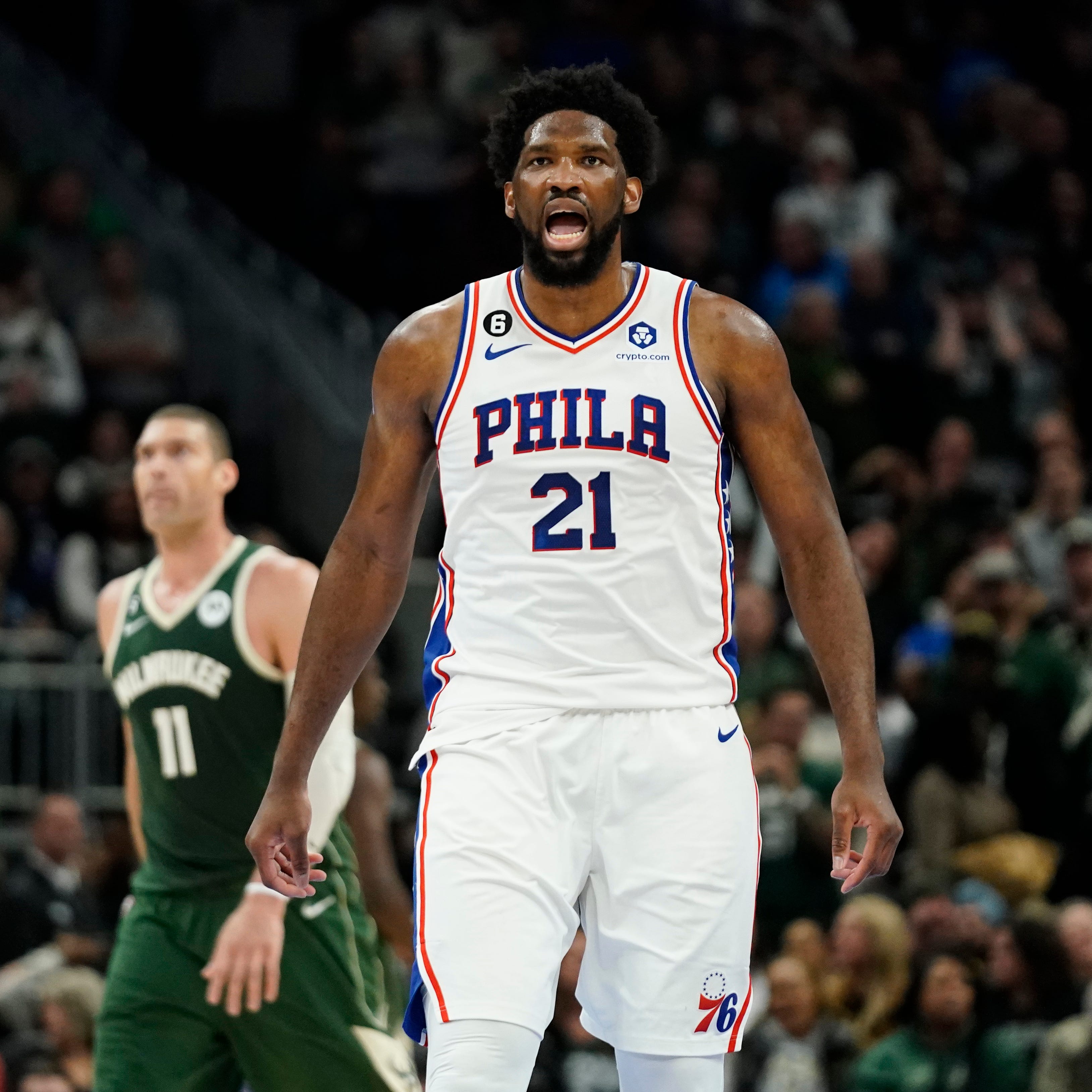 Joel Embiid reacts after making a basket.