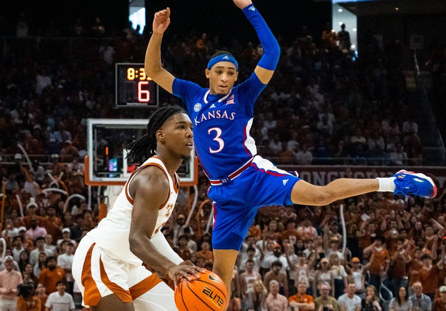 Texas guard Marcus Carr lines up a shot after a fake sent Kansas guard Dajuan Harris Jr. into the air prematurely.