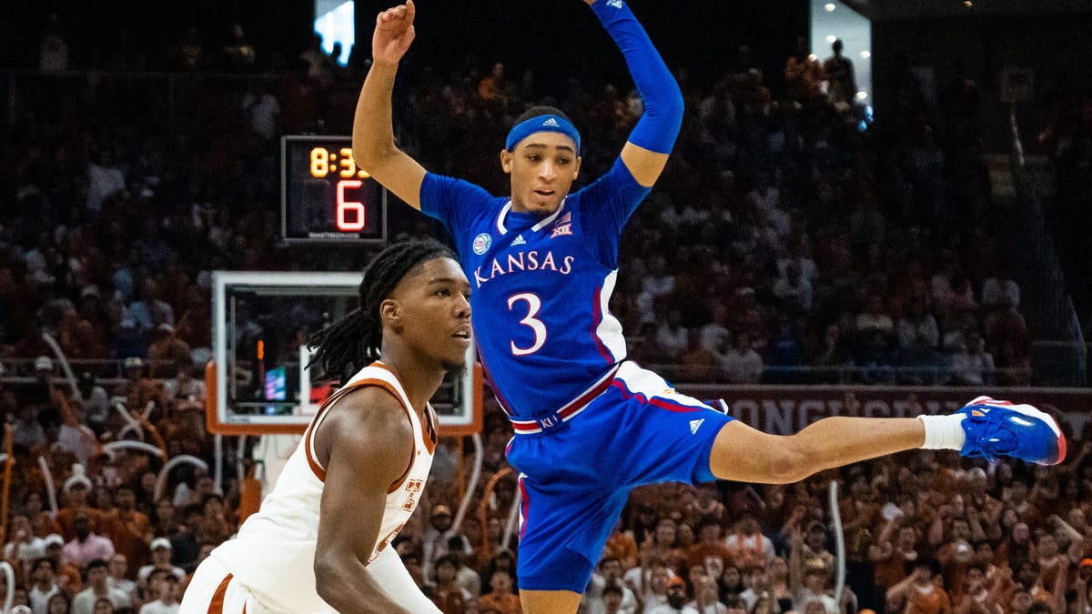 Texas guard Marcus Carr lines up a shot after a fake sent Kansas guard Dajuan Harris Jr. into the air prematurely.