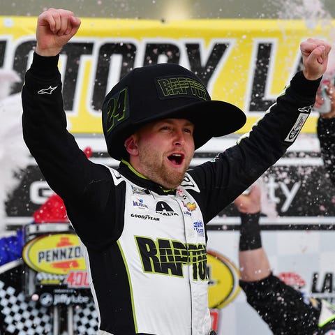 William Byron celebrates after winning the Pennzoi