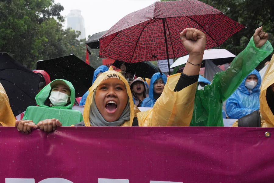 Women activists shout slogan during a rally celebrating International Women's Day in Jakarta, Indonesia, Wednesday, March 8, 2023.