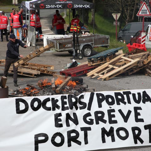 Striking dockers occupy a road leading to the port