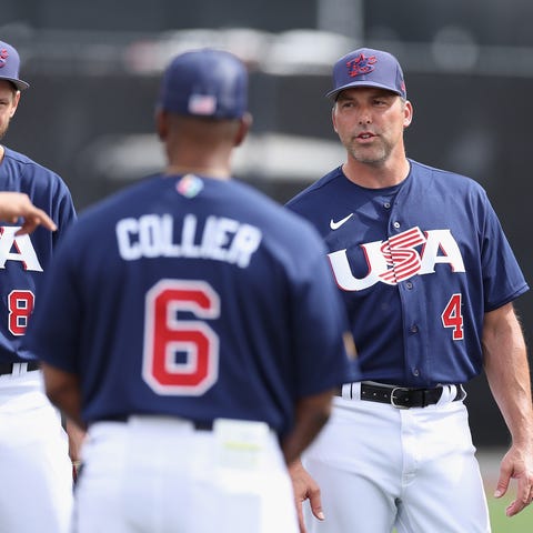 Team USA manager Mark DeRosa talks with teammates 