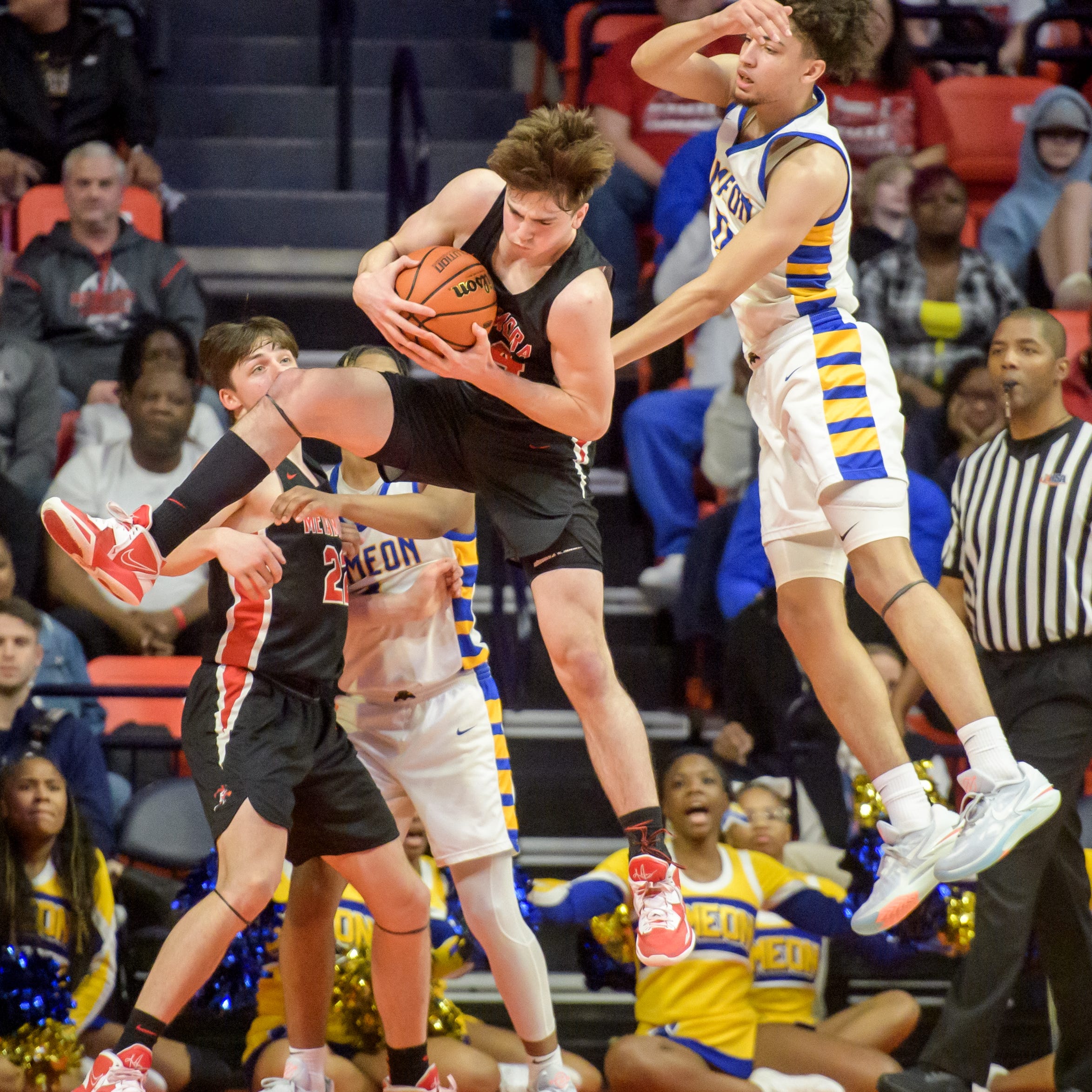 Metamora's Drew Tucker, left, brings down a rebound over Chicago Simeon's Sam Lewis in the overtime period of the Class 3A basketball state title game Saturday, March 11, 2023 at State Farm Center in Champaign. The Redbirds took the title 46-42.