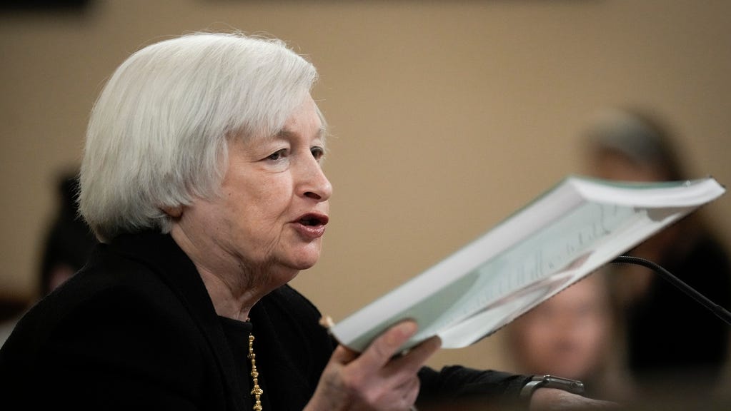 U.S. Treasury Secretary Janet Yellen holds up a copy of the Treasury Departments Greenbook as she testifies during a House Ways and Means Committee hearing on Capitol Hill March 10, 2023 in Washington, DC.