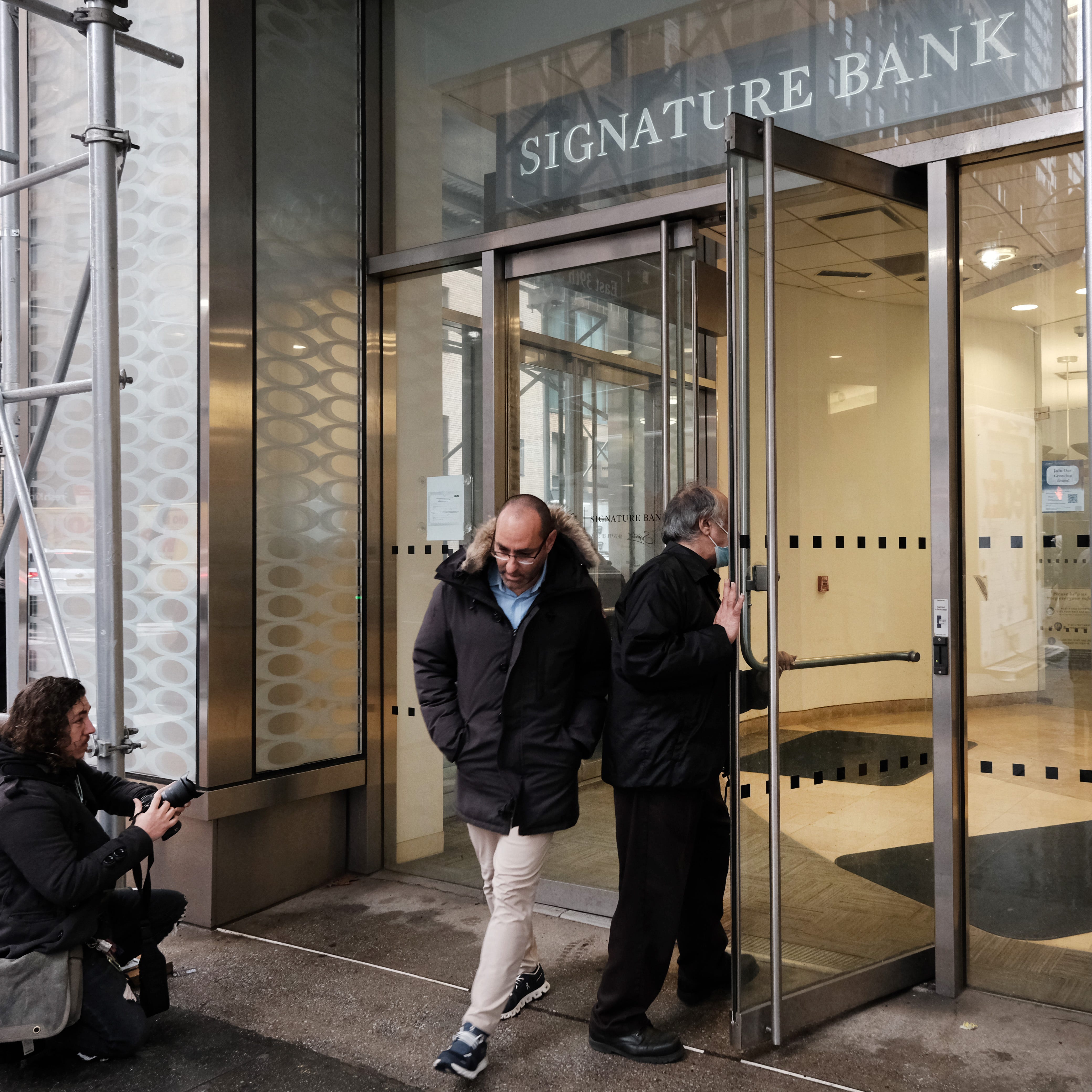 A man walks out of a Manhattan branch of Signature Bank which was closed by bank regulators on Sunday on March 13, 2023 in New York City. The move by the state's Department of Financial Services seeks to prevent a banking crisis spurred by the failure of Silicon Valley Bank.