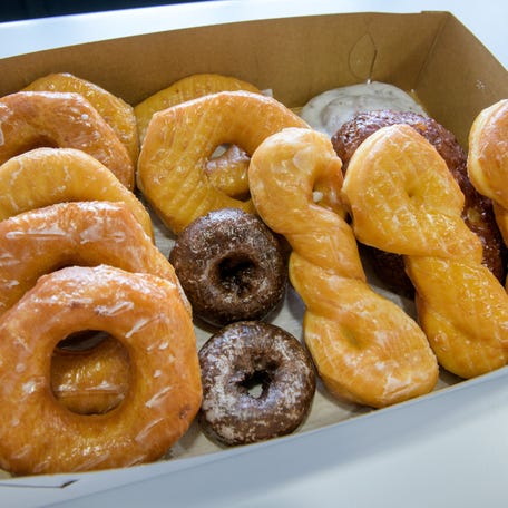 Freshly-made doughnuts are boxed up and ready for a customer at Tadoughs in Pekin.