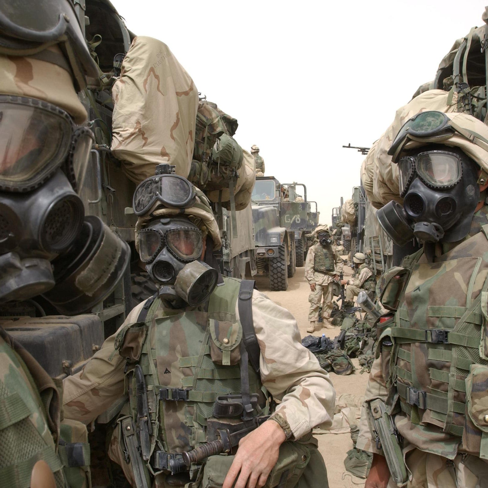 US Marines from the 2nd battalion/8th Marines wear their gas masks 21 March 2003 as they prepare to advance towards Iraq.