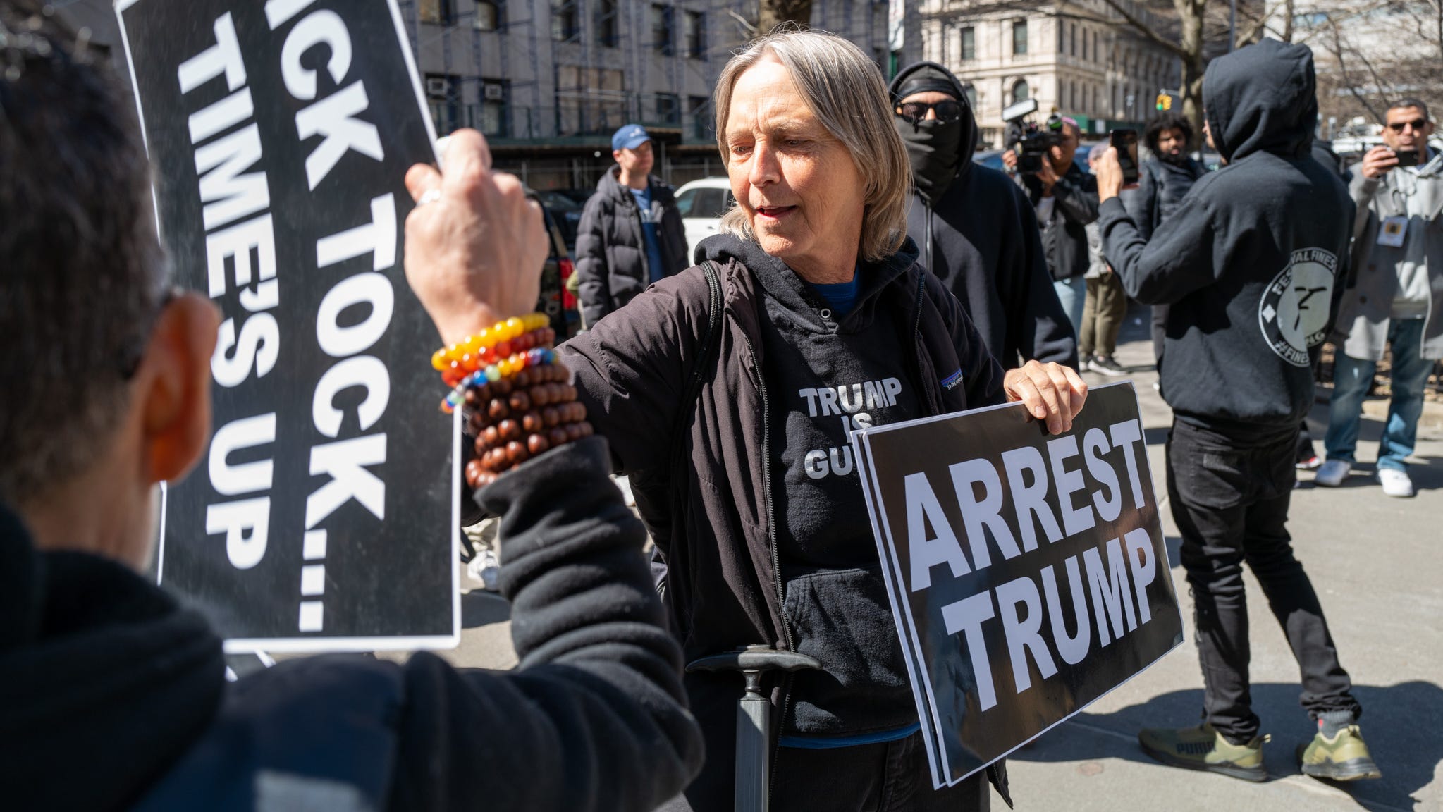 People gather outside a Manhattan courthouse as the nation waits for the possibility of an indictment against former President Donald Trump by the Manhattan District Attorney Alvin Bragg's office on March 21, 2023 in New York City.