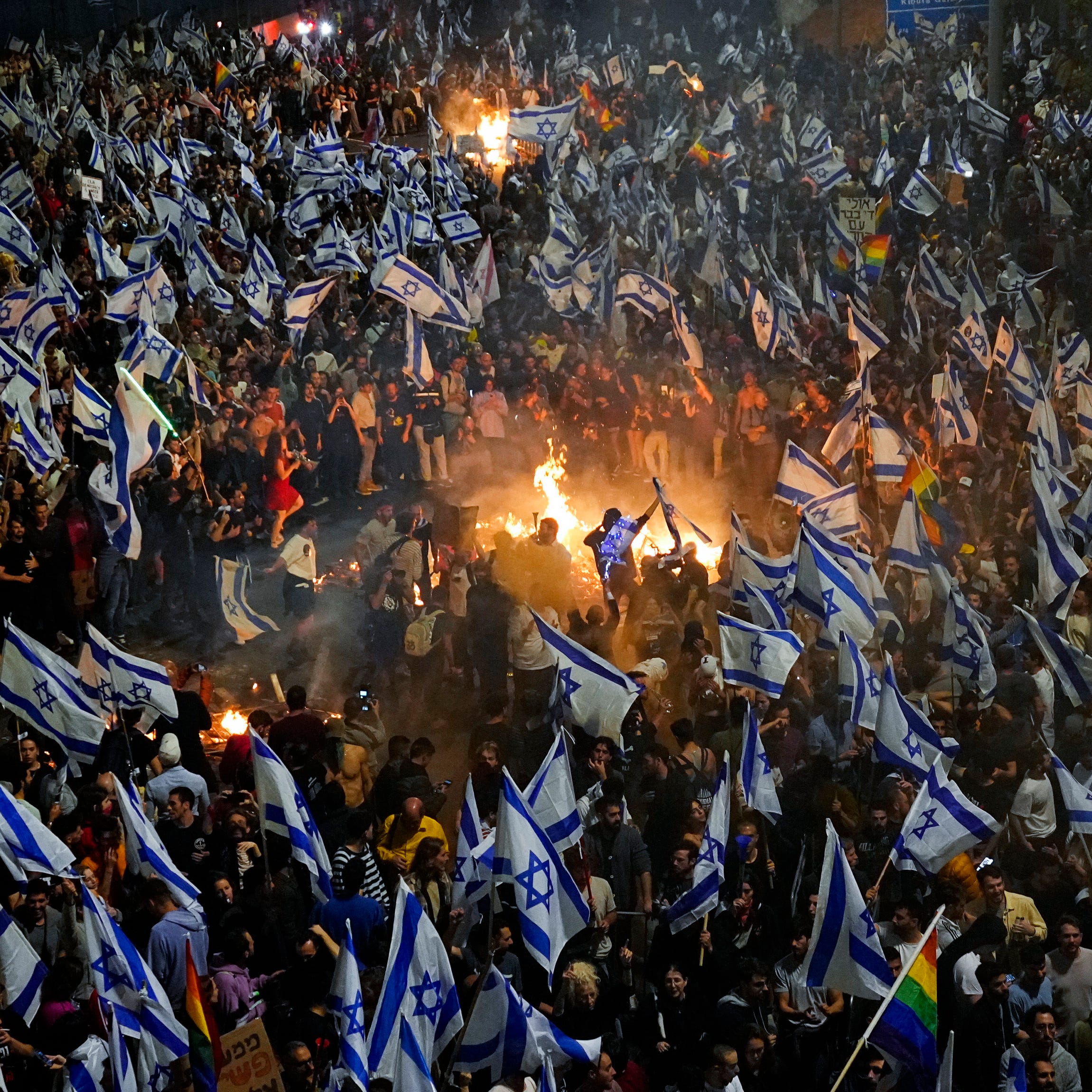 Israelis opposed to Prime Minister Benjamin Netanyahu's judicial overhaul plan set up bonfires and block a highway during a protest moments after the Israeli leader fired his defense minister, in Tel Aviv, Israel, Sunday, March 26, 2023. Defense Minister Yoav Gallant had called on Netanyahu to freeze the plan, citing deep divisions in the country and turmoil in the military.