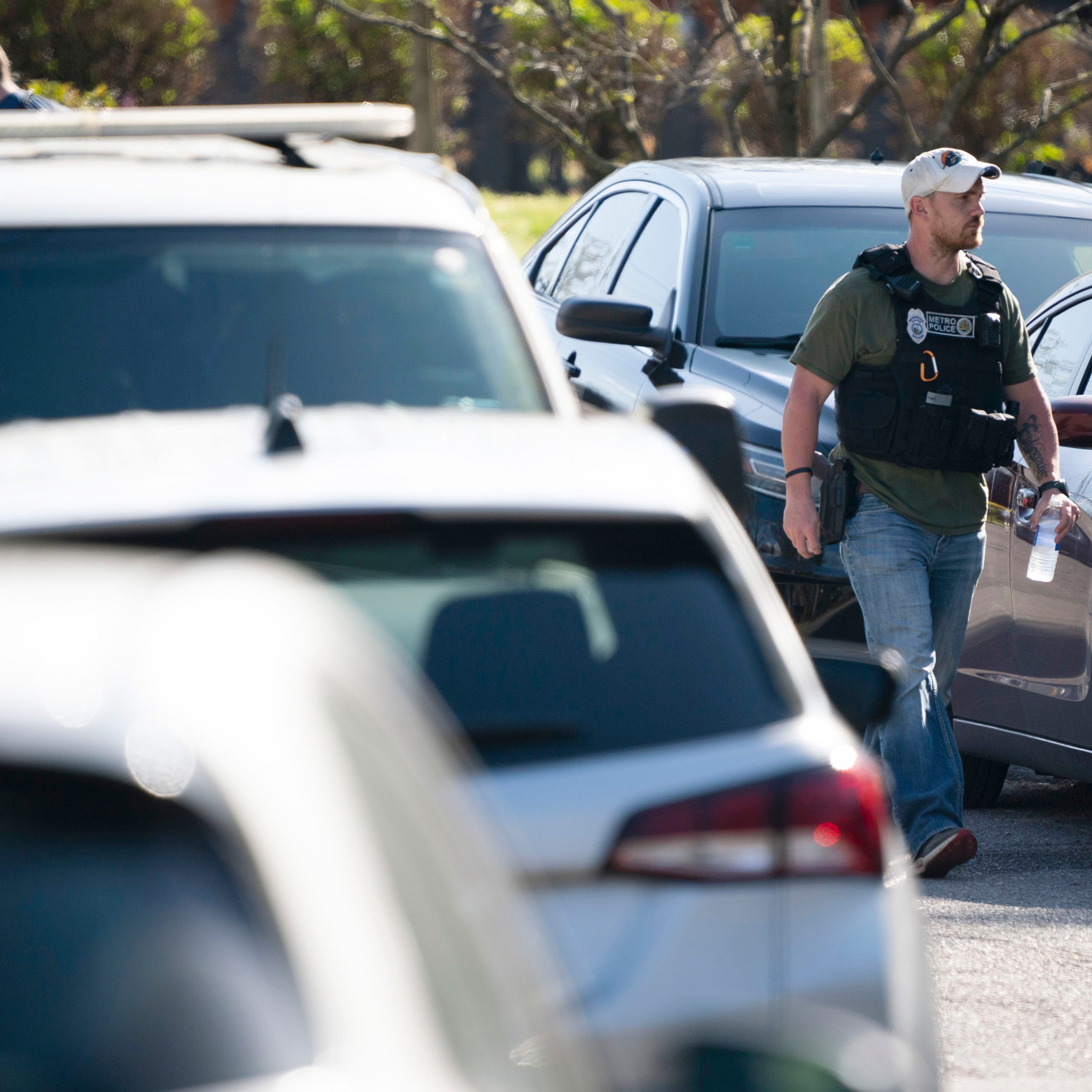 Metro Nashville Police and federal law enforcement agencies search and investigate a house in the 3000 block of Brightwood Ave. following a mass shooting at Covenant School, Monday, March 27, 2023, in Nashville, Tenn. The shooter was killed by police on the scene. (Andrew Nelles/The Tennessean via AP) ORG XMIT: TNNAT420