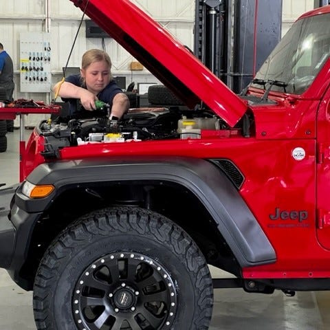 Jaiden Parker, a technician trainee, is seen here March 20, 2023 working at Southwest Ford in Weatherford, Texas.