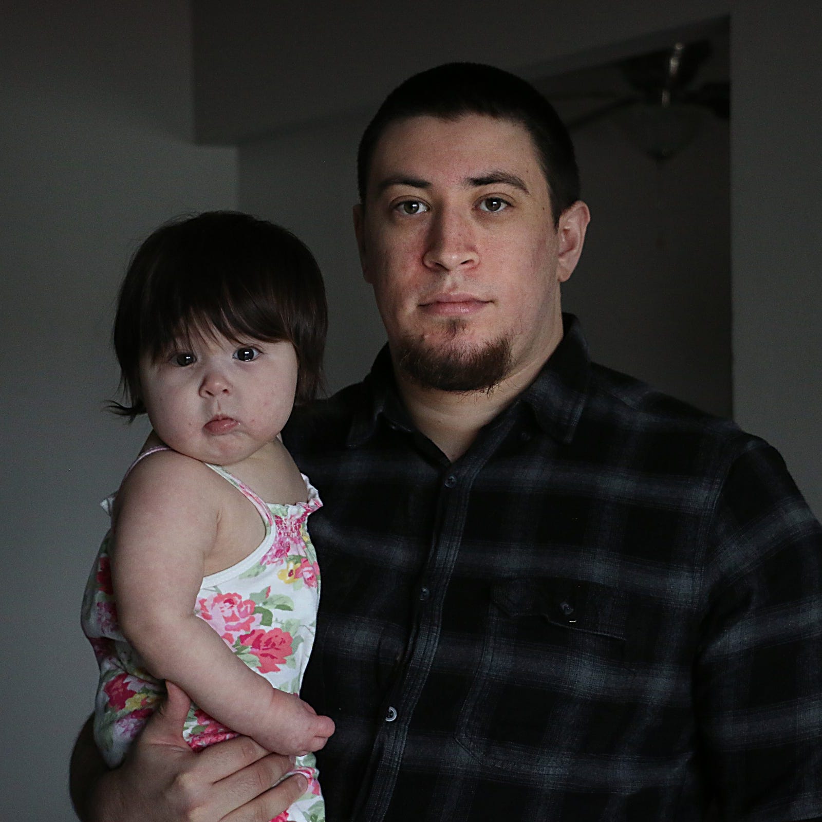 Elijah Johnson poses for a portrait with his daughter Azriela-Nova in their apartment in Reno on March 28, 2023.