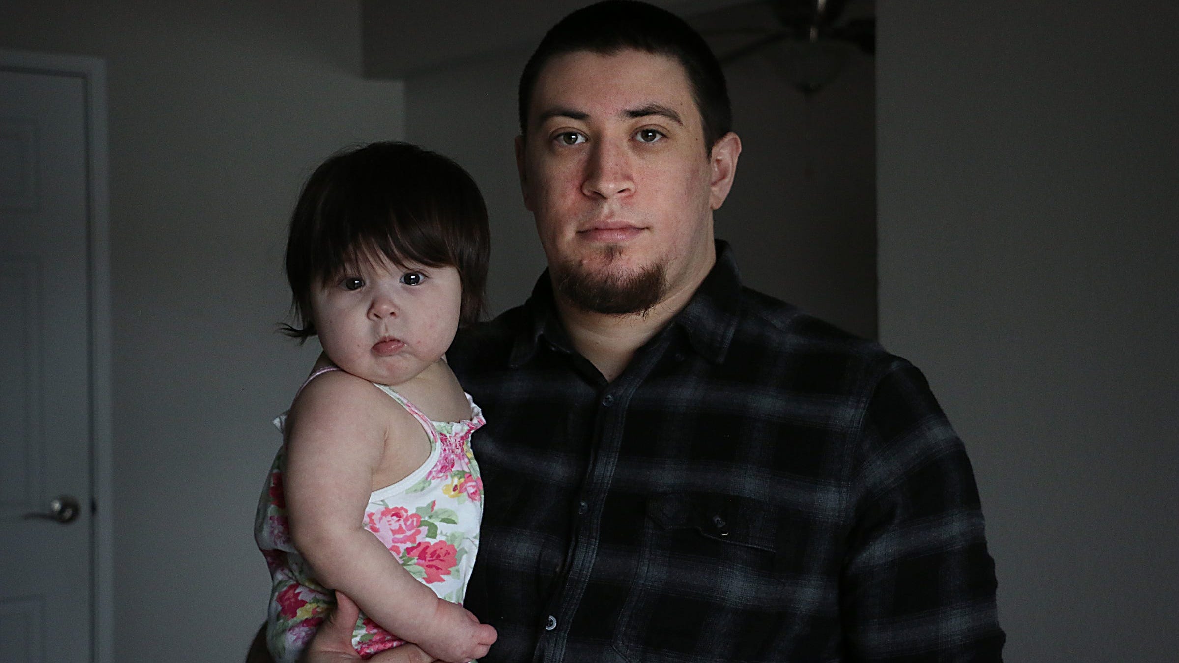 Elijah Johnson poses for a portrait with his daughter Azriela-Nova in their apartment in Reno on March 28, 2023.