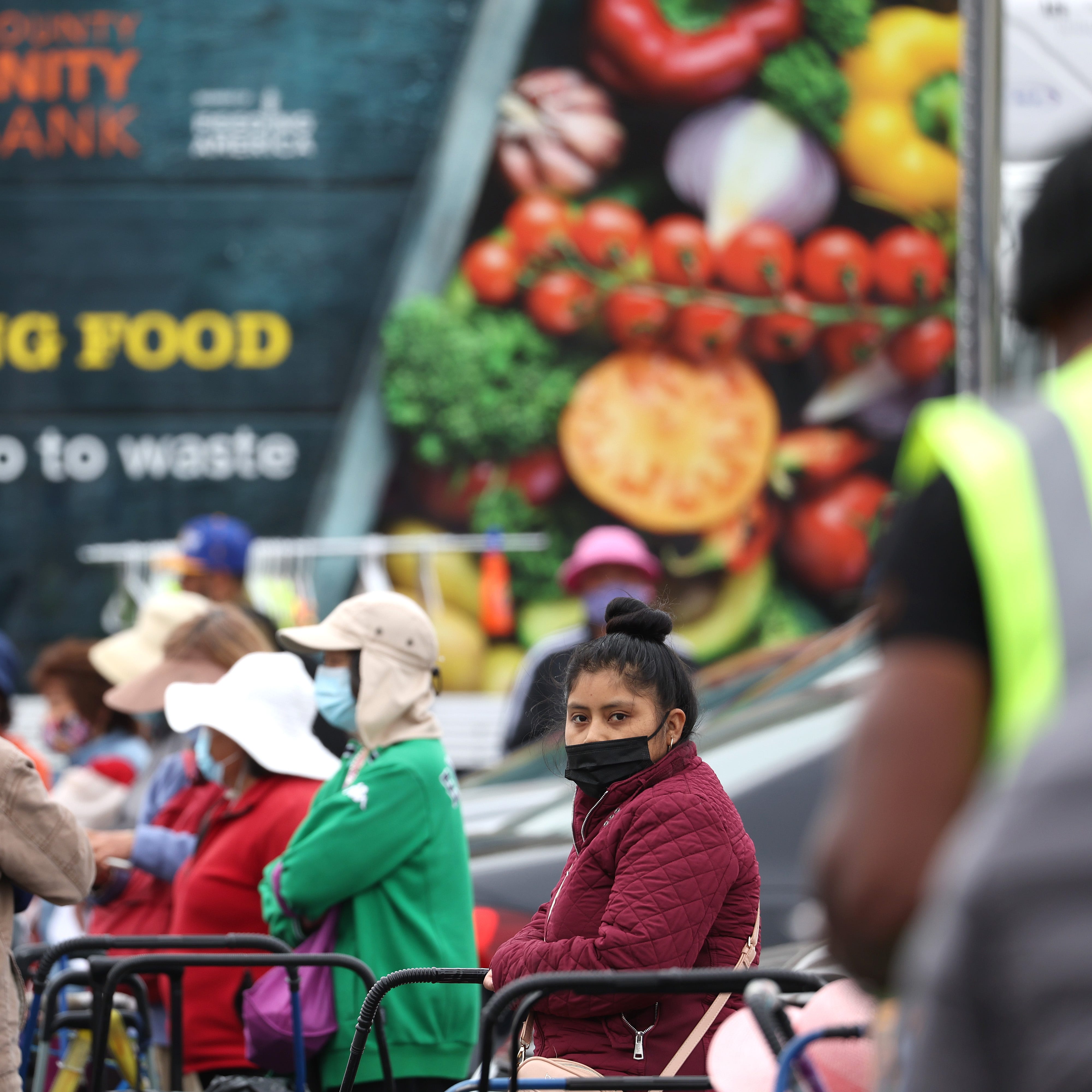 People wait in line at a food bank on July 15, 2022, in Oakland, Calif.