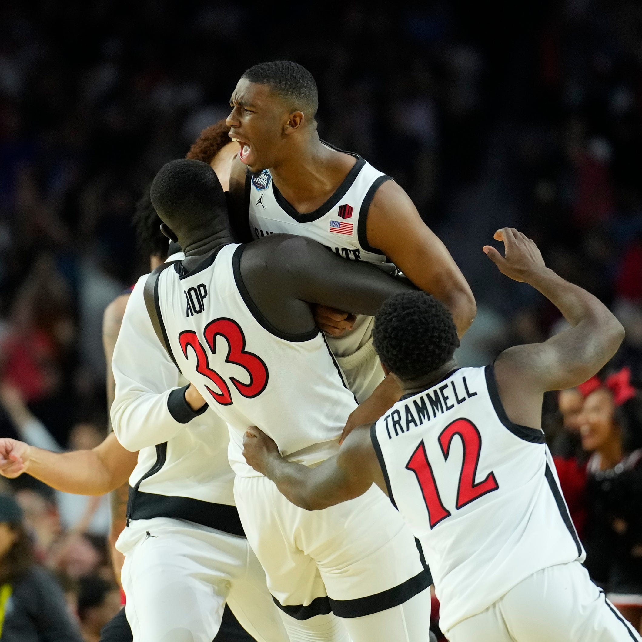 San Diego State guard Lamont Butler celebrates with teammates after hitting the game-winner as time expired.