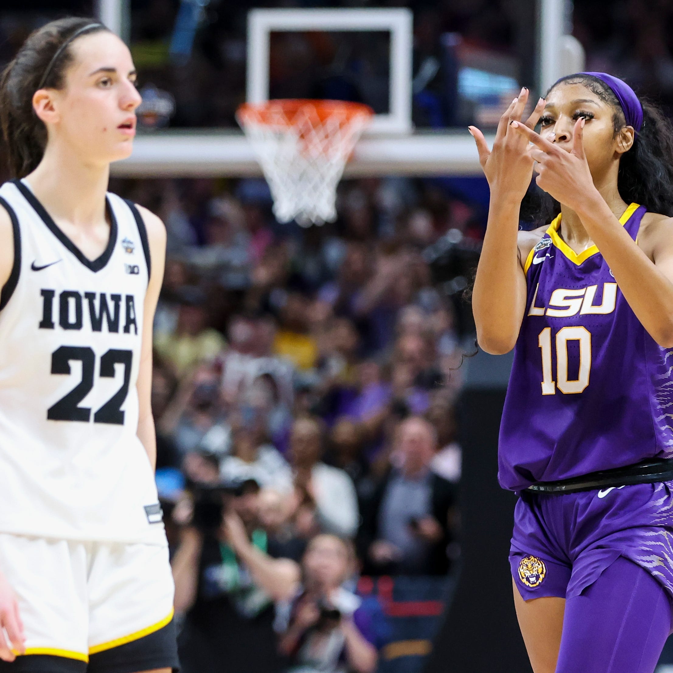 LSU's Angel Reese gestures toward Iowa's Caitlin Clark after the Tigers won the women's national championship.