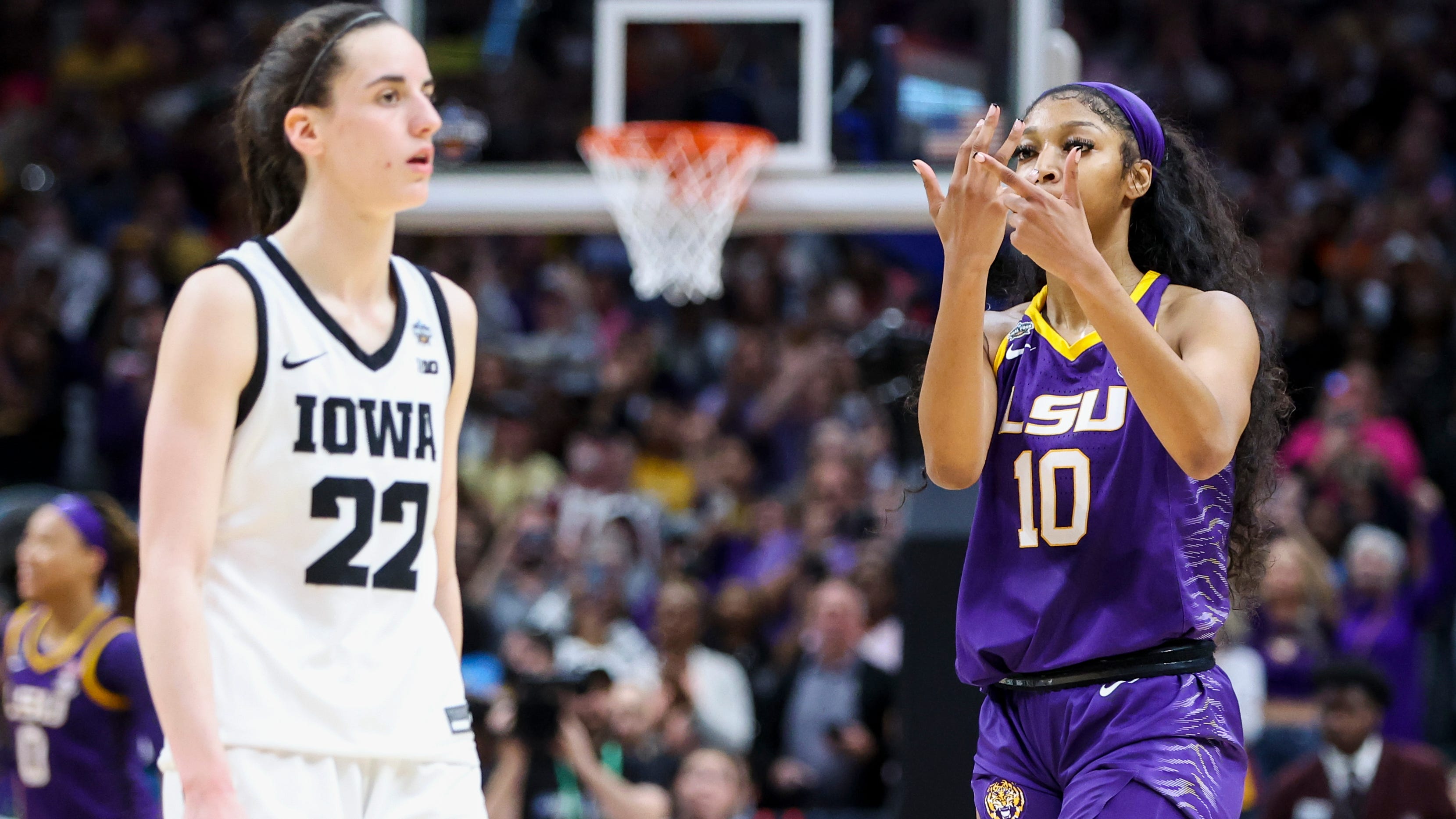 LSU's Angel Reese gestures toward Iowa's Caitlin Clark after the Tigers won the women's national championship.