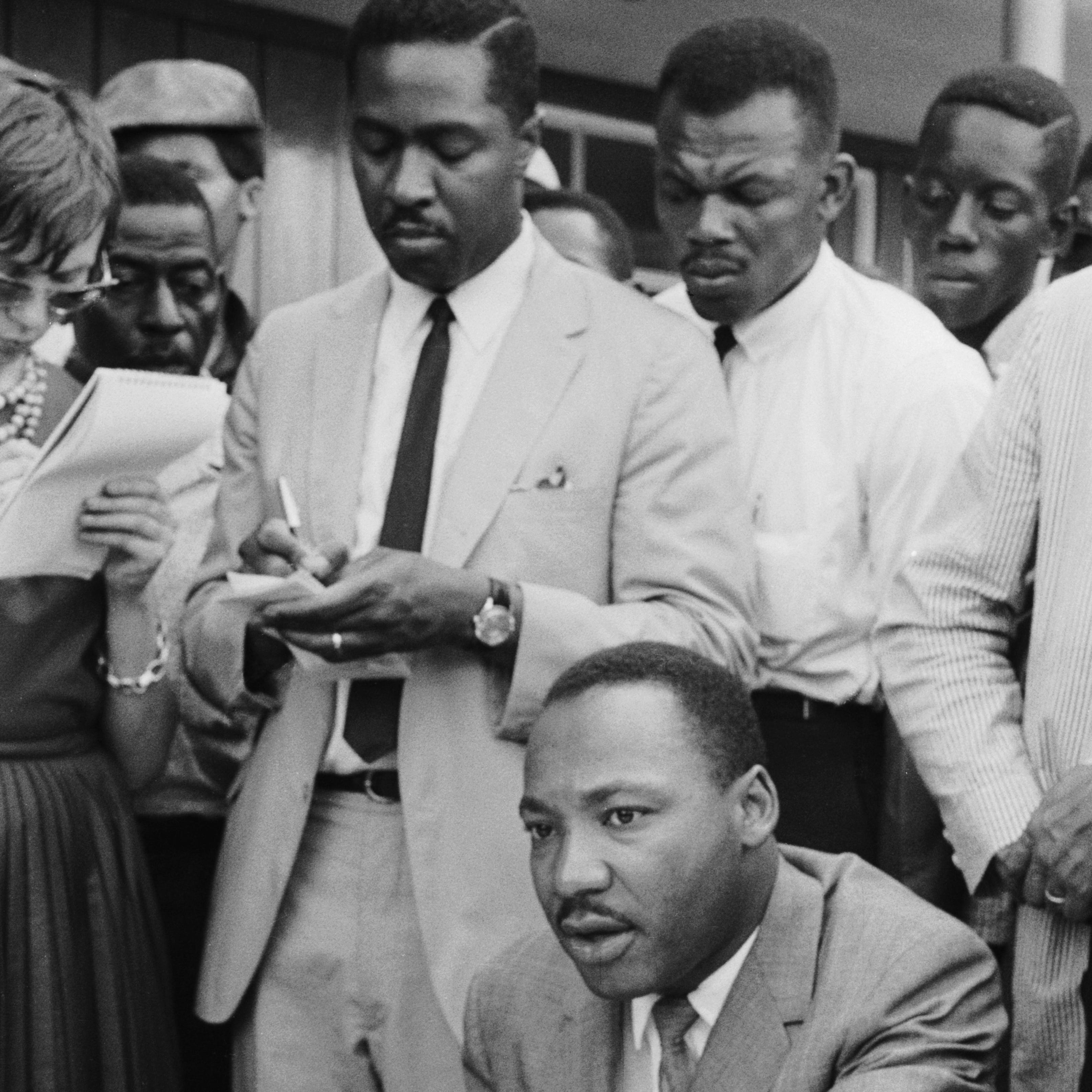 The Rev. Martin Luther King Jr. at a news conference in Birmingham, Ala., in 1963. Taking notes behind him is his speechwriter, Clarence B. Jones.