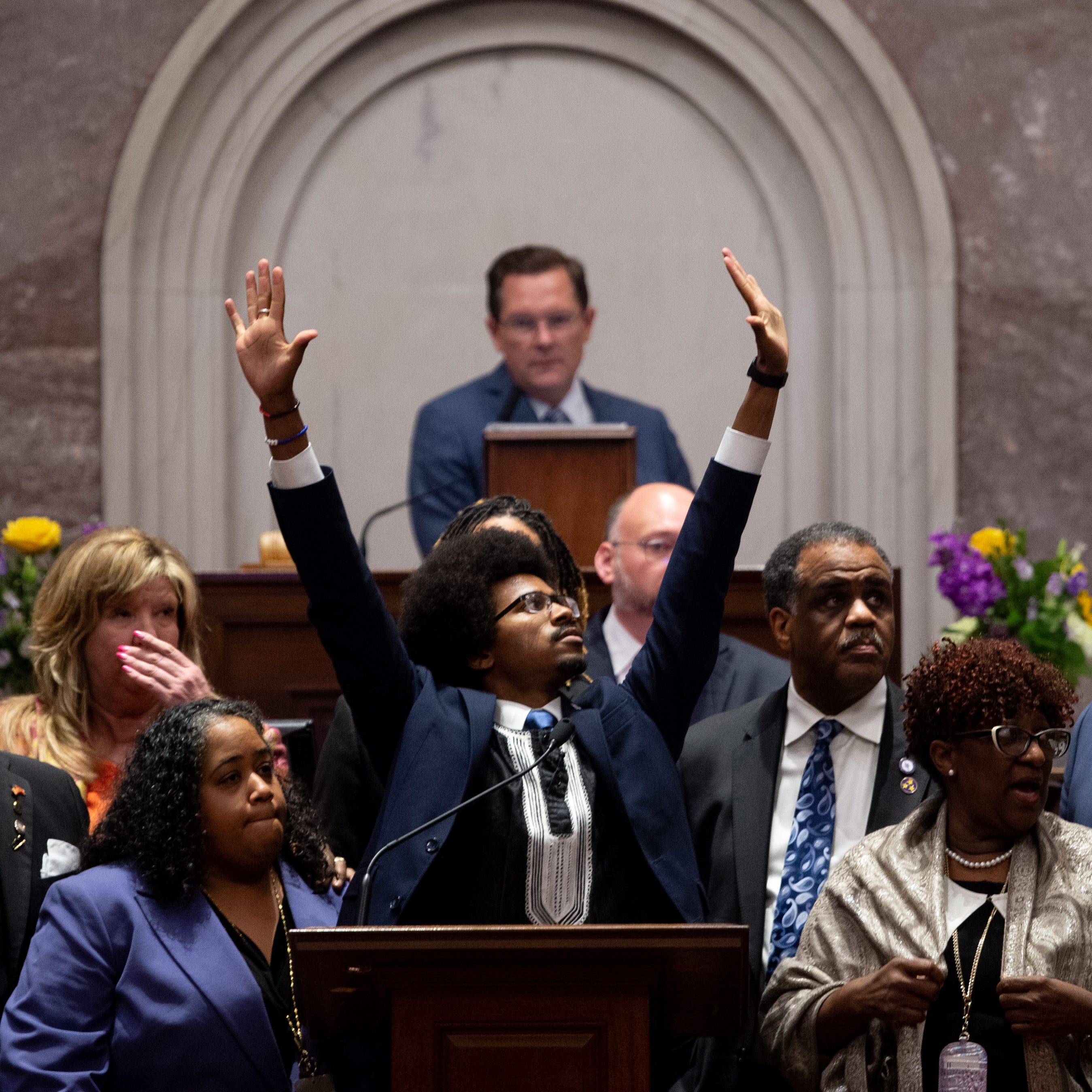 Justin Pearson, D-Memphis, holds his hands in the air during a vote to expel him from the House of Representatives at the Tennessee State Capitol in Nashville, Tenn., on Thursday, April 6, 2023. House Speaker Cameron Sexton appears behind him.