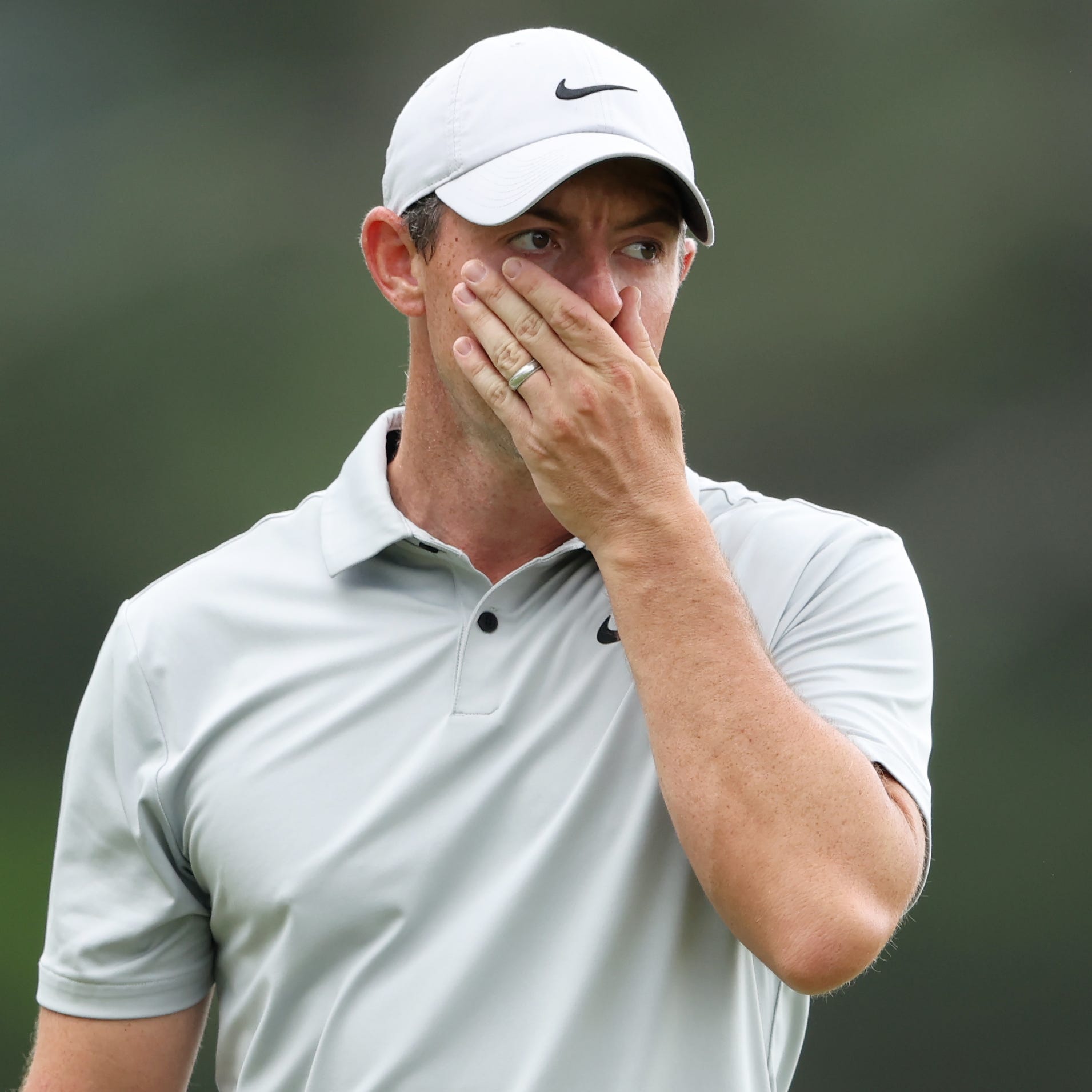 Rory McIlroy reacts to a putt on the 18th green during the second round of the Masters.