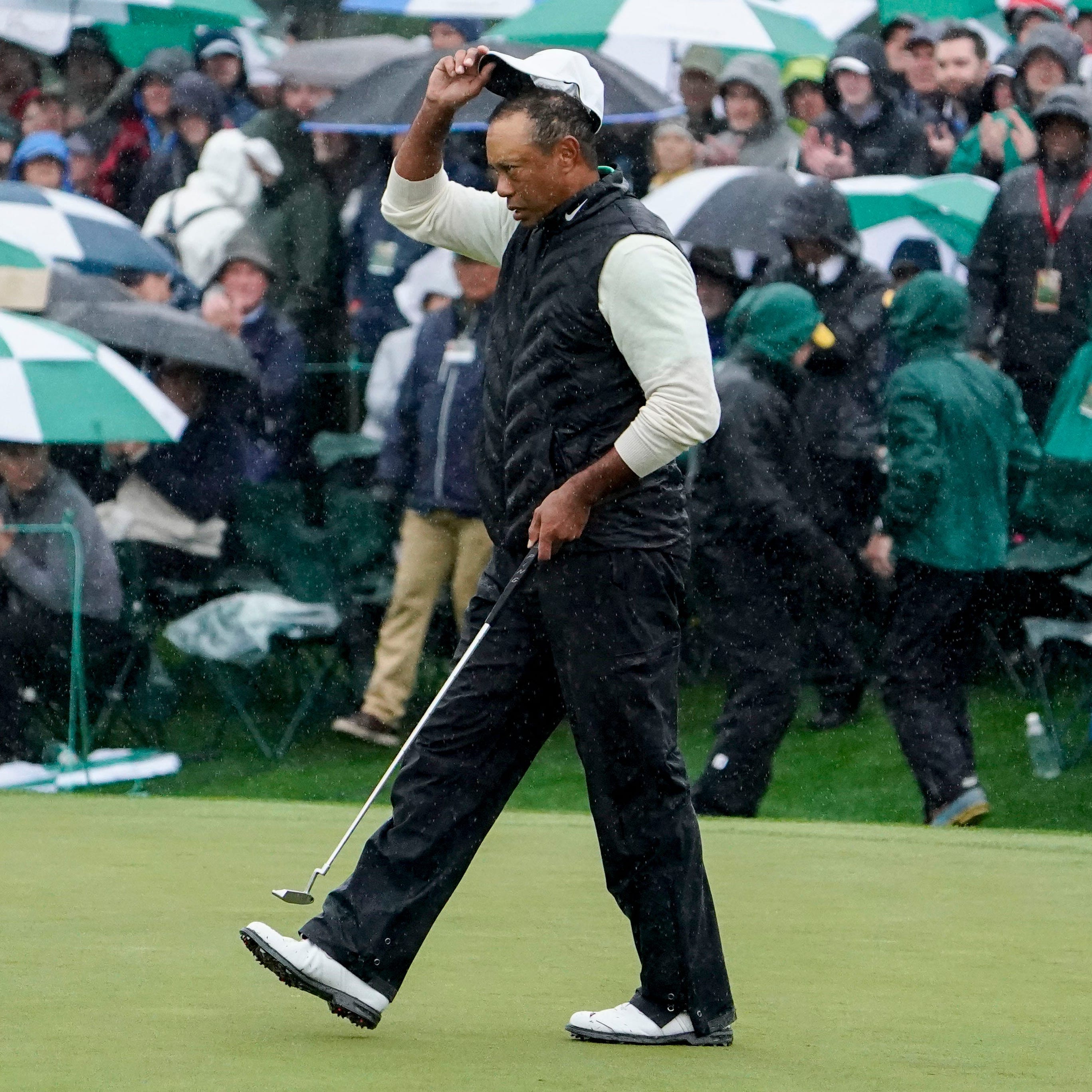 Tiger Woods walks the 18th green on Saturday.