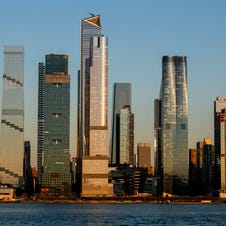 FILE - Light from the setting sun falls on the Hudson Yards neighborhood in the borough of Manhattan in New York City, as seen from the Weehawken Pier in Weehawken, N.J., Wednesday, March 22, 2023. The county that encompasses Manhattan added more than 17,000 residents in the year ending last July after losing almost 111,000 people in the previous 12-month period, according to population estimates released Thursday, March 30, 2023, by the U.S. Census Bureau. (AP Photo/Ted Shaffrey, File)