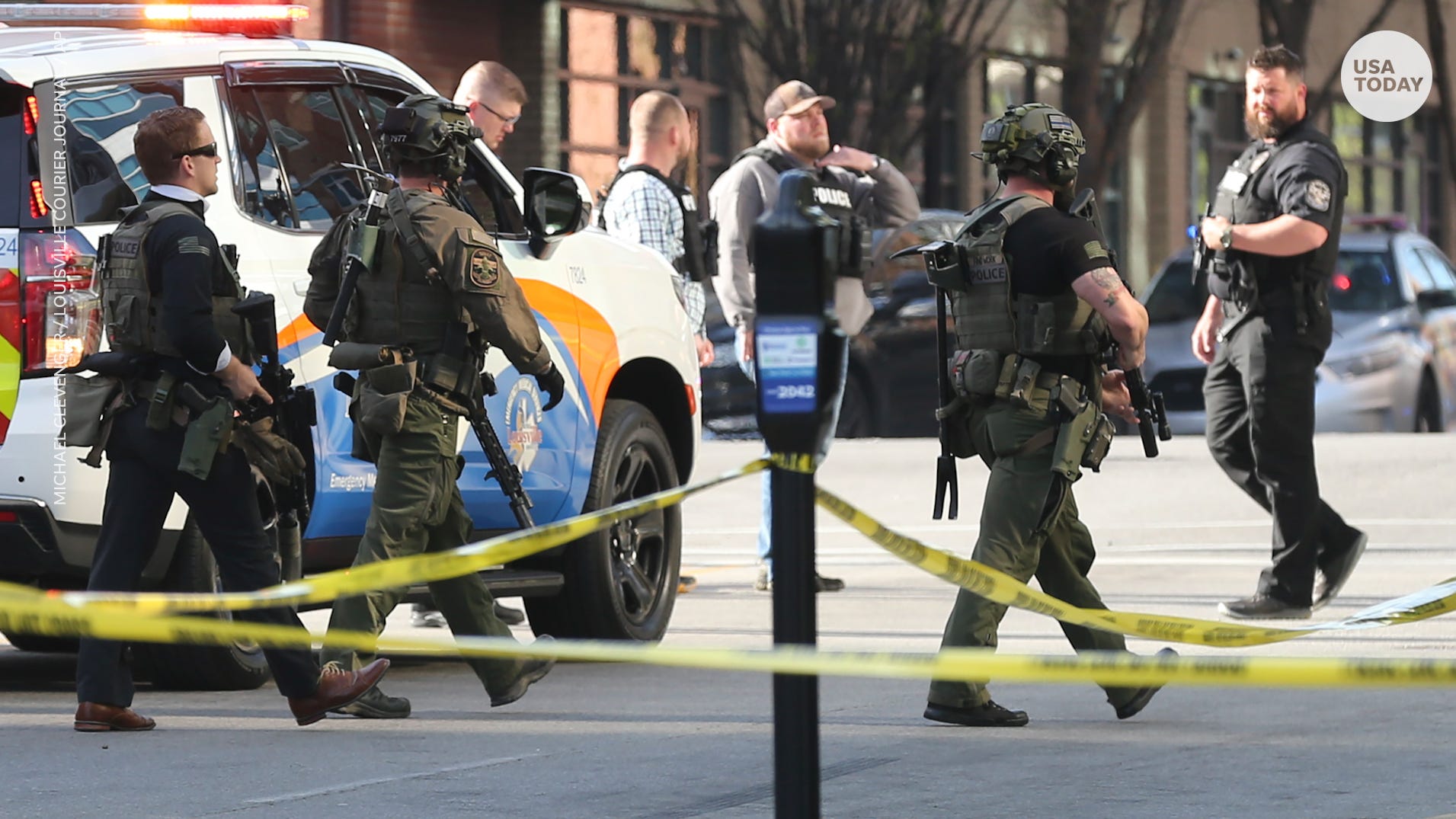 Multiple agencies arrive at a building after a shooting took place in Louisville, Ky., Monday, April 10, 2023. (Michael Clevenger/Courier Journal via AP)