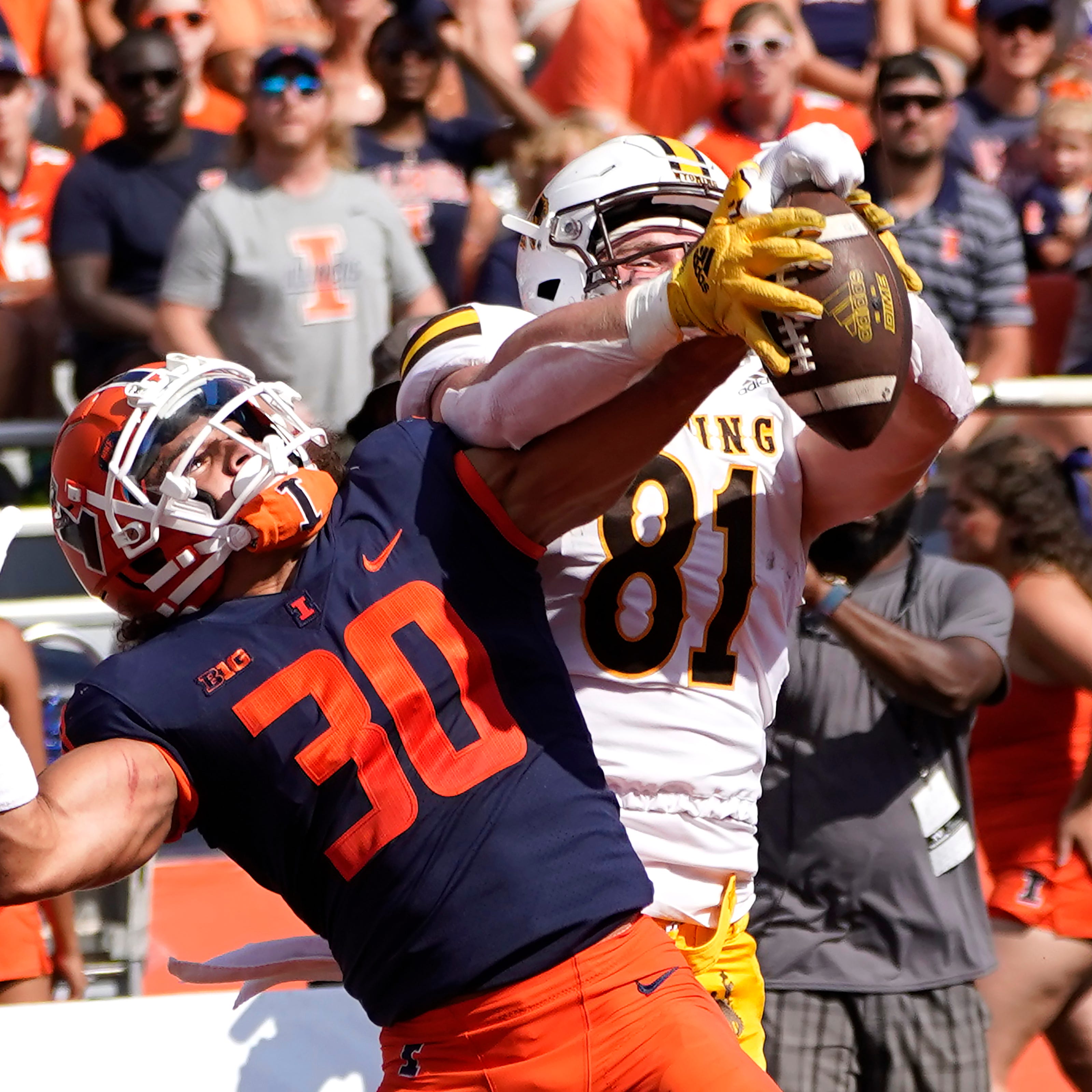 Illinois defensive back Sydney Brown (30) breaks up a pass intended for Wyoming tight end Treyton Welch in the end zone during an NCAA college football game, Sunday, Aug. 28, 2022, in Champaign, Ill. (AP Photo/Charles Rex Arbogast)