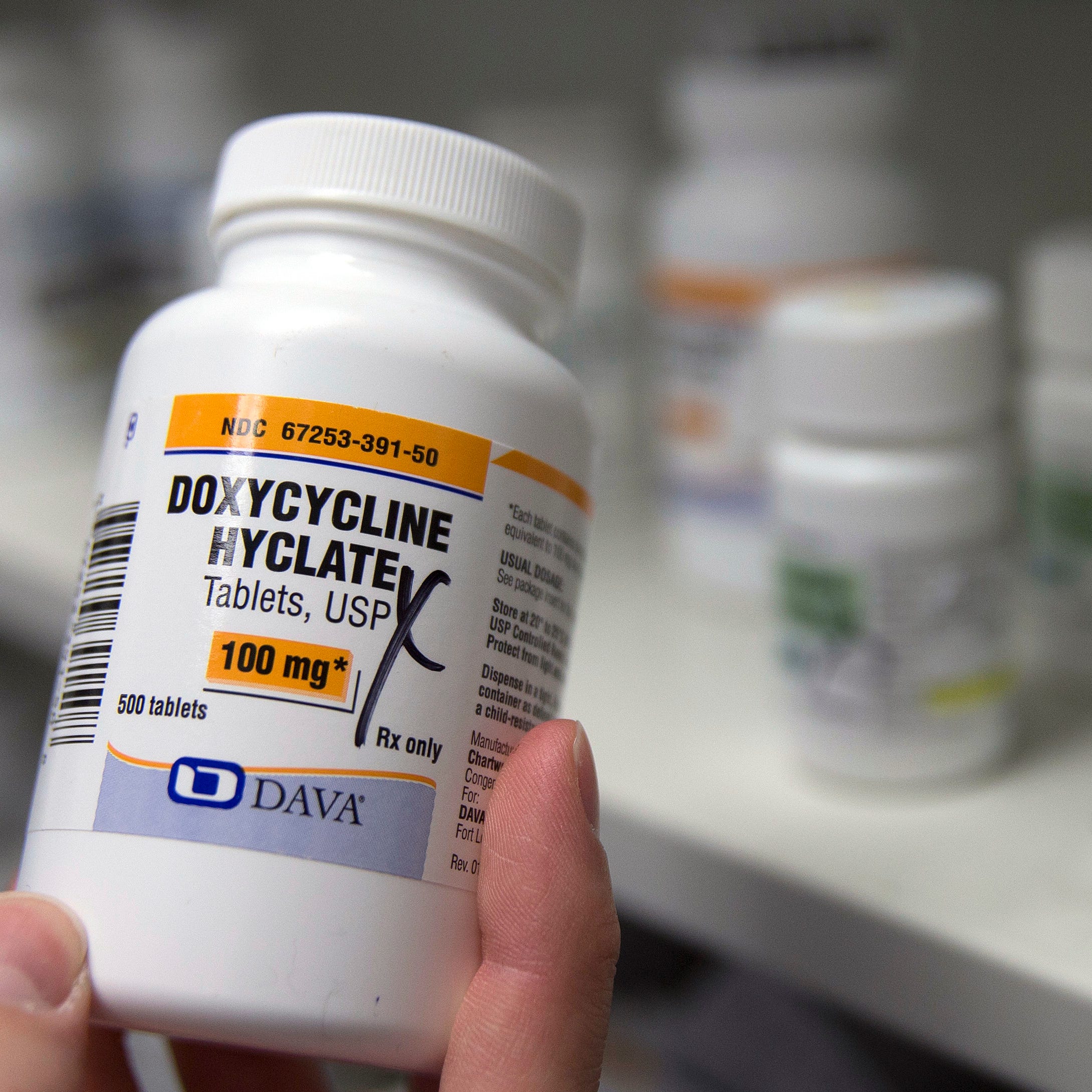 FILE - A pharmacist holds a bottle of the antibiotic doxycycline hyclate in Sacramento, Calif., July 8, 2016. On Tuesday, April 11, 2023, the Centers for Disease Control and Prevention released data about some of the most common infectious diseases in the U.S. The numbers show how chlamydia, gonorrhea and syphilis infections have been accelerating across the country. Meanwhile, the CDC is considering recommending the antibiotic doxycycline to be used after sex to prevent those infections. (AP Photo/Rich Pedroncelli,   File)