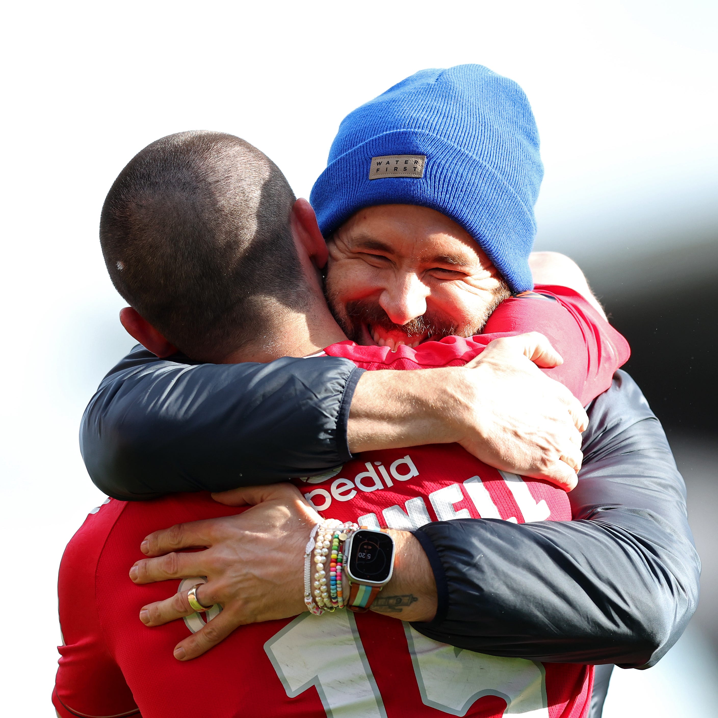 Ryan Reynolds hugs Eoghan O'Connell of Wrexham after their victory over Notts County at The Racecourse.