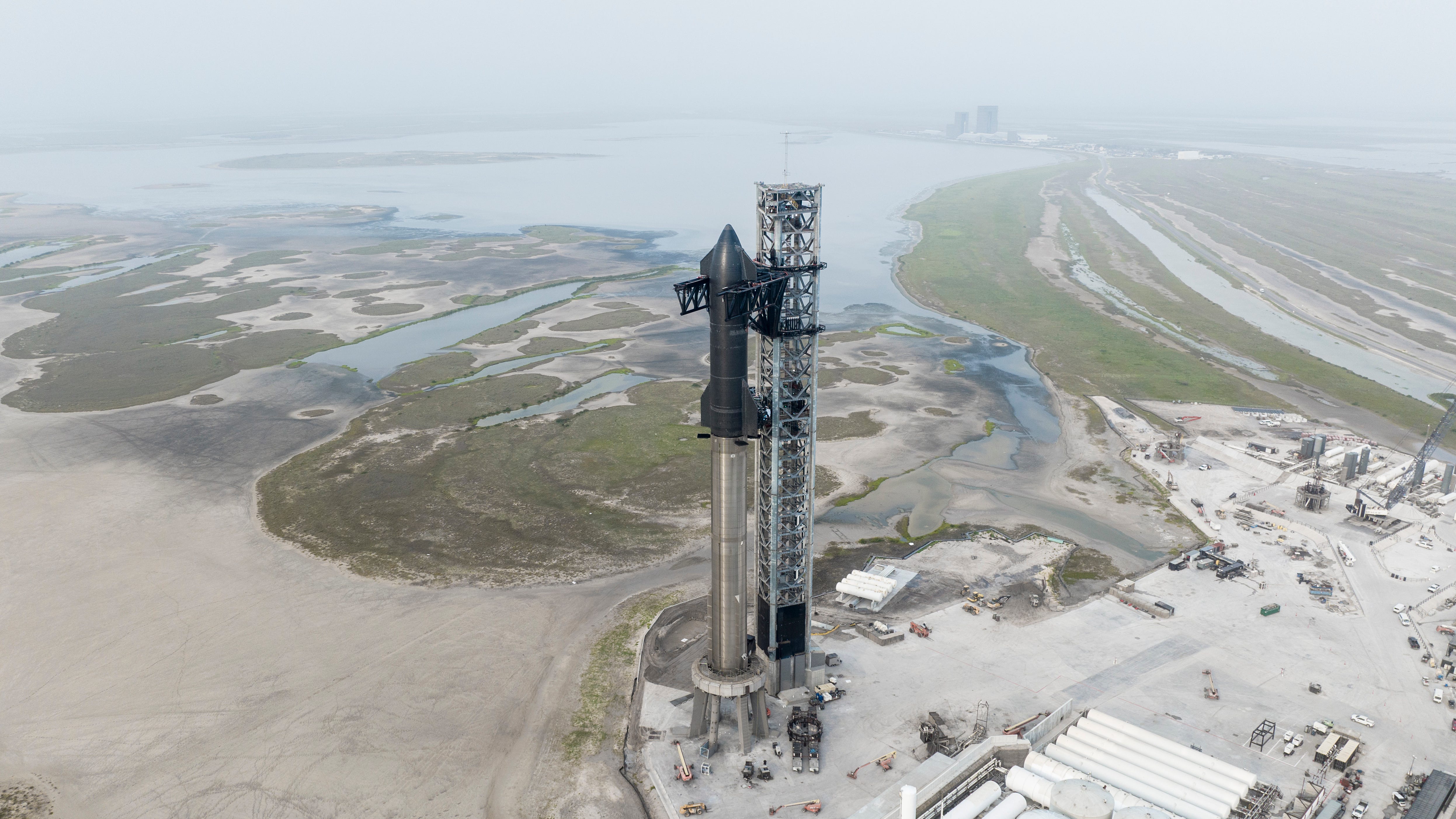 SpaceX's Starship and Super Heavy booster are seen on the company's launch mount near at Starbase, Texas, in April 2023. This booster and Starship are slated to fly the first orbital test flight.