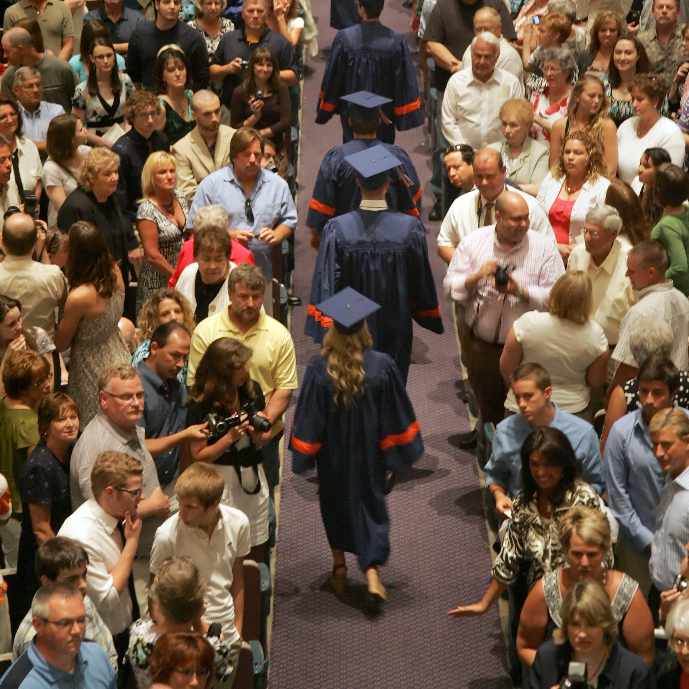 Family and friends attend the commencement ceremony for high school graduates.