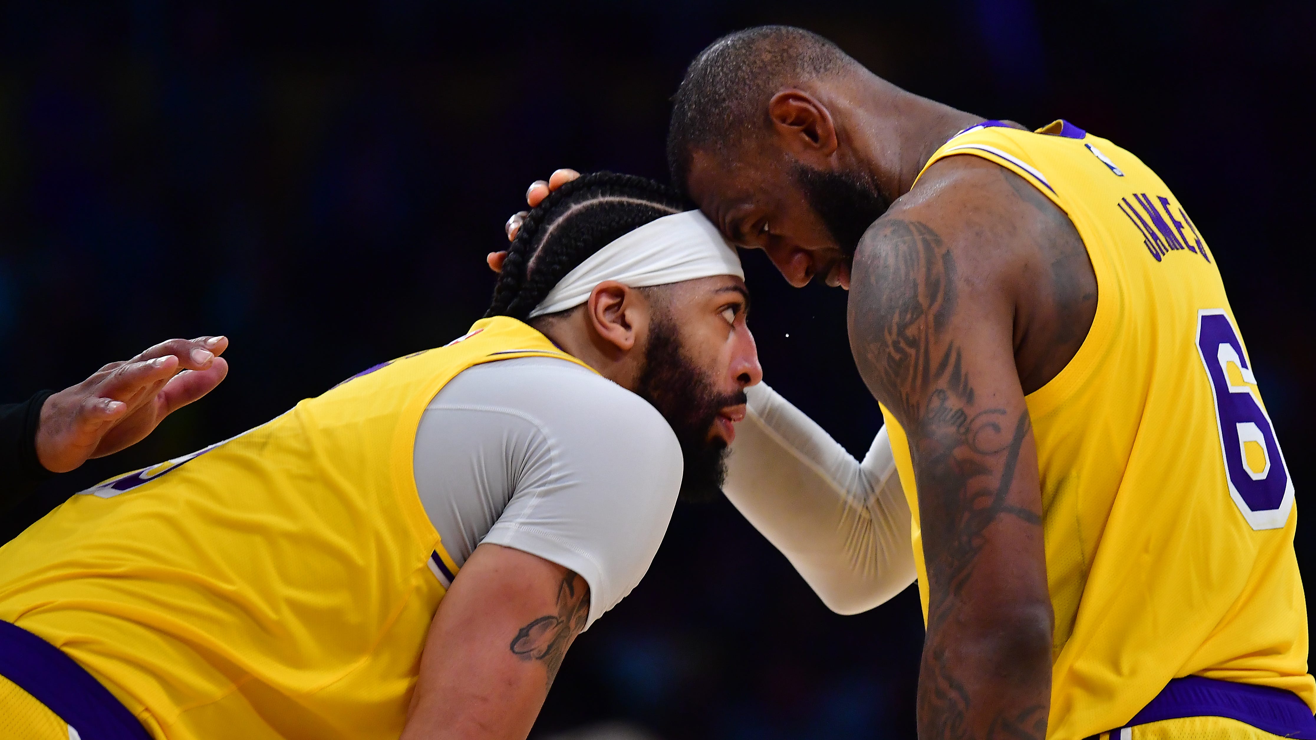 Los Angeles Lakers forward LeBron James speaks with forward Anthony Davis during a stoppage in play during the second half against the Minnesota Timberwolves.