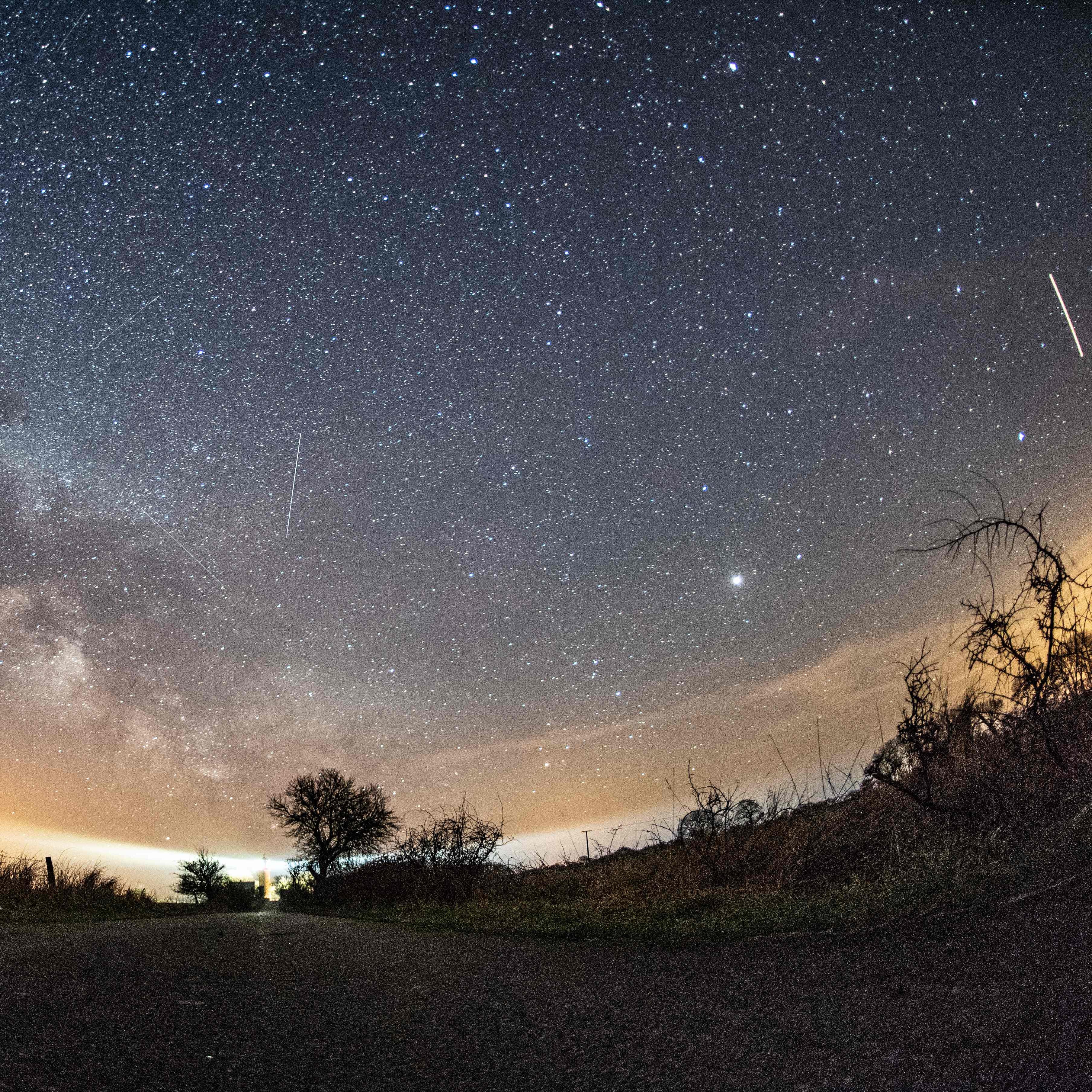 The milky way and meteors of the April Lyrids annual meteor shower are seen in the night sky over Burg auf Fehmarn on the Baltic Sea island of Fehmarn, northern Germany, on April 20, 2018.