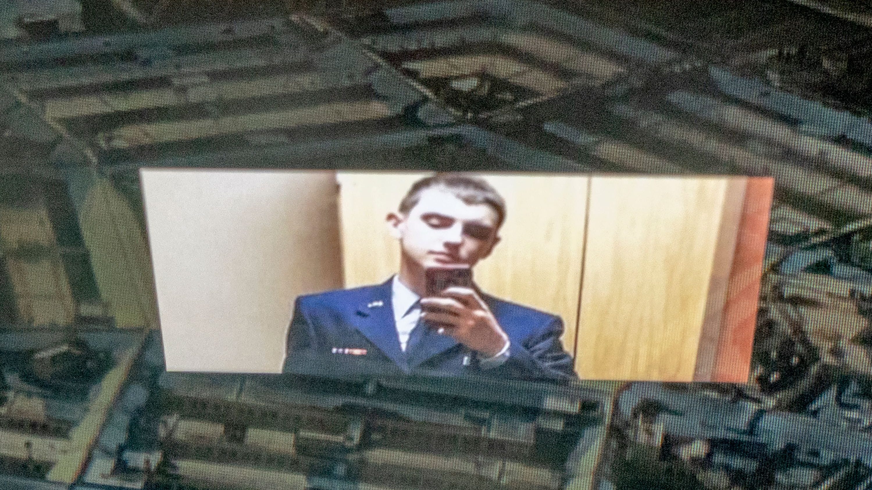 This photo illustration created on April 13, 2023, shows the suspect, national guardsman Jack Teixeira, reflected in an image of the Pentagon in Washington, D.C.