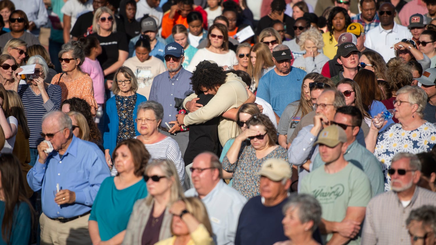 Community members embrace during a prayer vigil at First Baptist Church in Dadeville, Ala., on Sunday, April 16, 2023. A deadly shooting happened late Saturday night at Mahogany Masterpiece dance studio in downtown Dadeville.