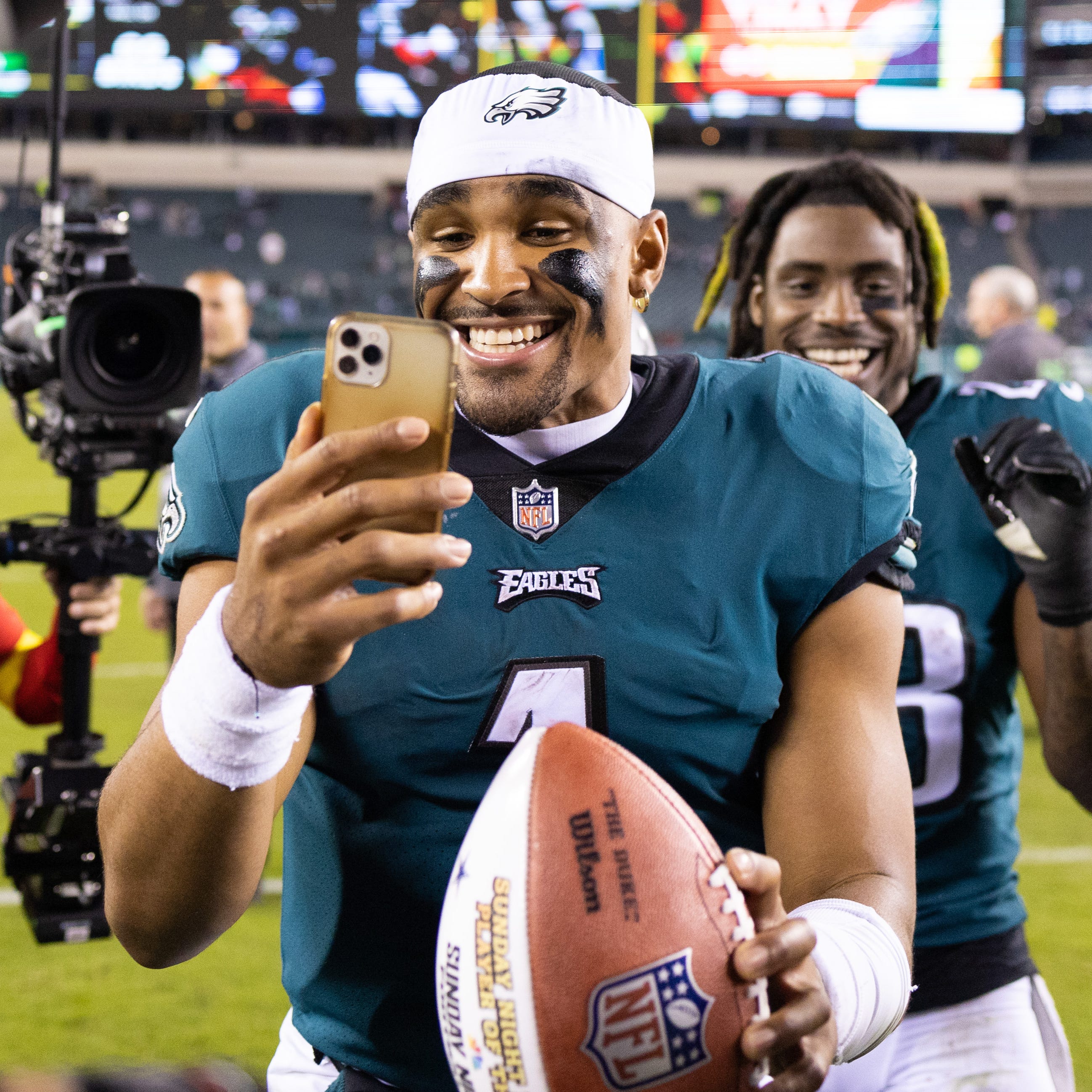 Philadelphia Eagles quarterback Jalen Hurts (1) celebrates with a game ball after a victory against the Dallas Cowboys at Lincoln Financial Field.