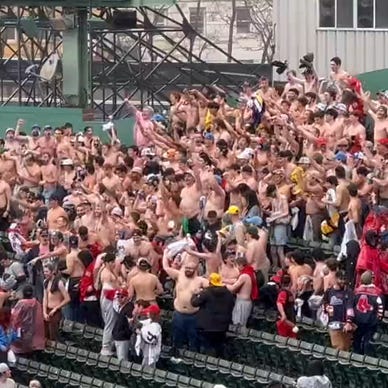 Red Sox fans go shirtless during lengthy rain delay at Fenway