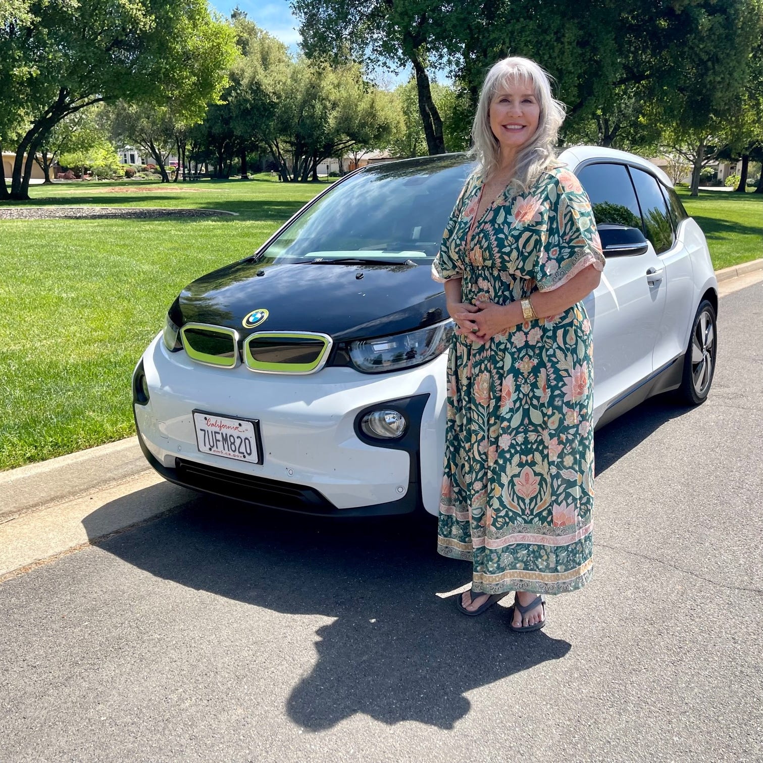 Mandi Kindred of Shingle Springs, California stands with the pre-owned 2016 BMW i3 electric vehicle she bought.