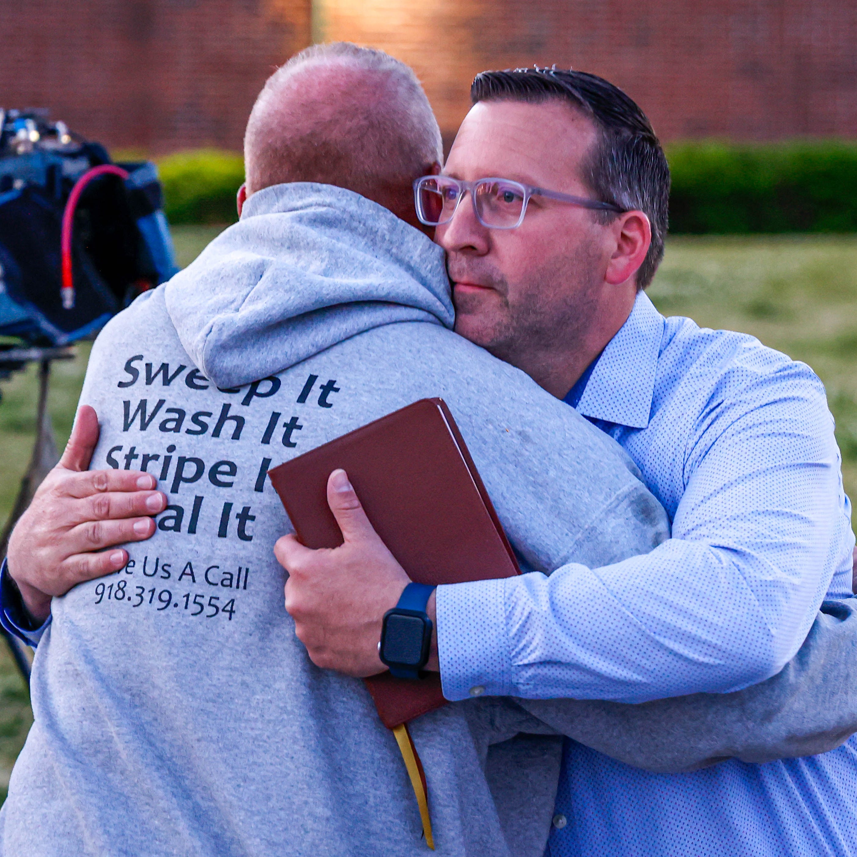 Pastor Ryan Wells hugs Nathan Brewer, the father of Brittany Brewer who was found dead, after a vigil in Henryetta Okla., on Monday, May 1, 2023.