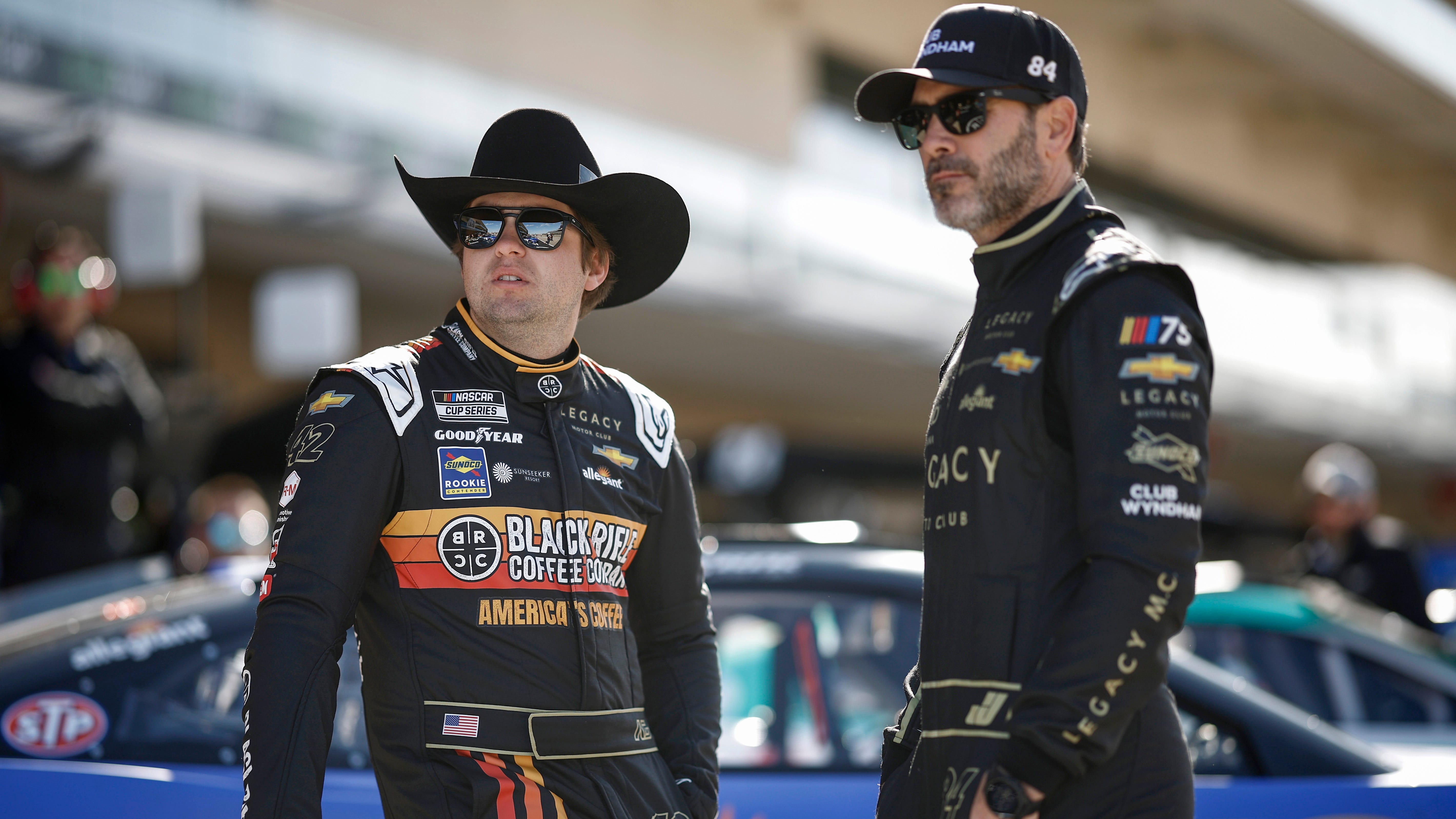 Legacy Motor Club driver Noah Gragson, left, taks with team co-owner, driver Jimmie Johnson at the Circuit of the Americas in Austin, Texas on March 25, 2023.