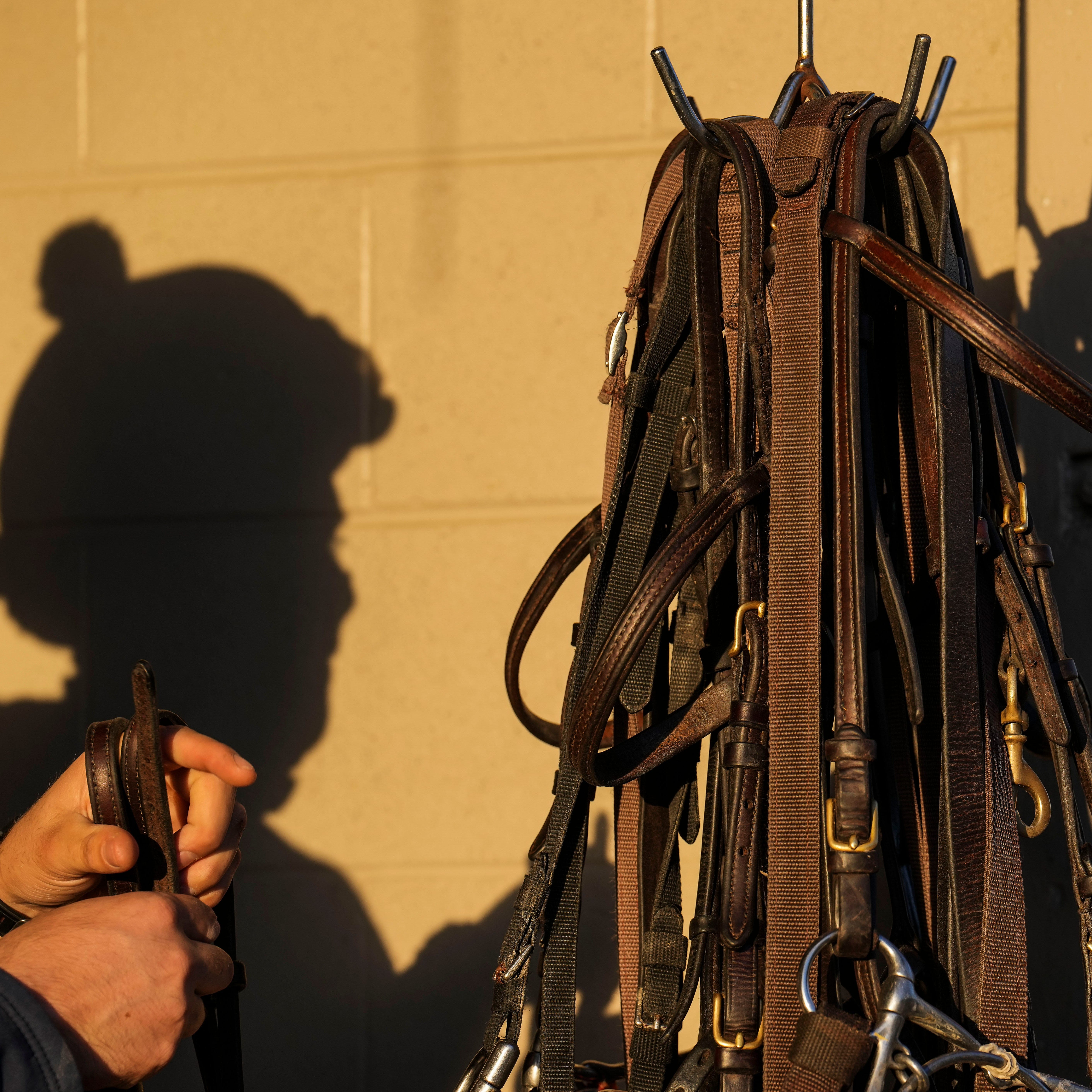 An exercise rider gets prepared for a workout Tuesday morning at Churchill Downs during Kentucky Derby week.