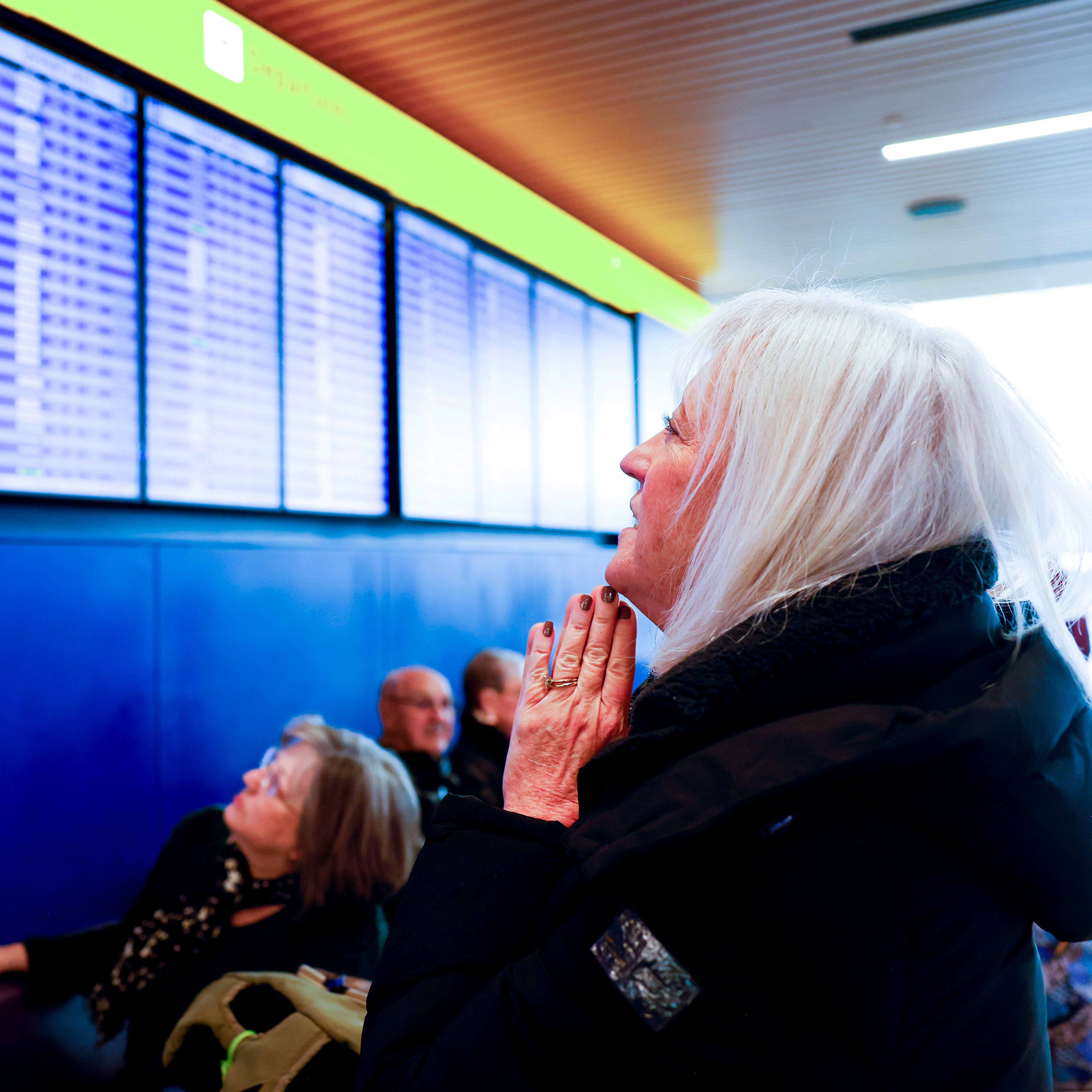 DENVER, CO - FEBRUARY 22: Cathi Vinson looks at a departures board at Denver International Airport showing canceled and delayed flights as she hopes to fly home to Houston during a winter storm on February 22, 2023 in Denver, Colorado. (Photo by Michael Ciaglo/Getty Images)