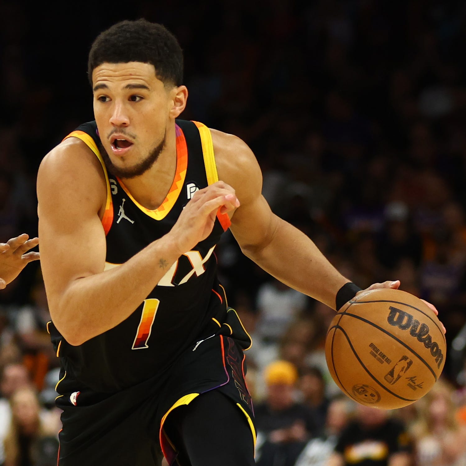 The Phoenix Suns' Devin Booker drives to the basket against the Denver Nuggets during Game 4.